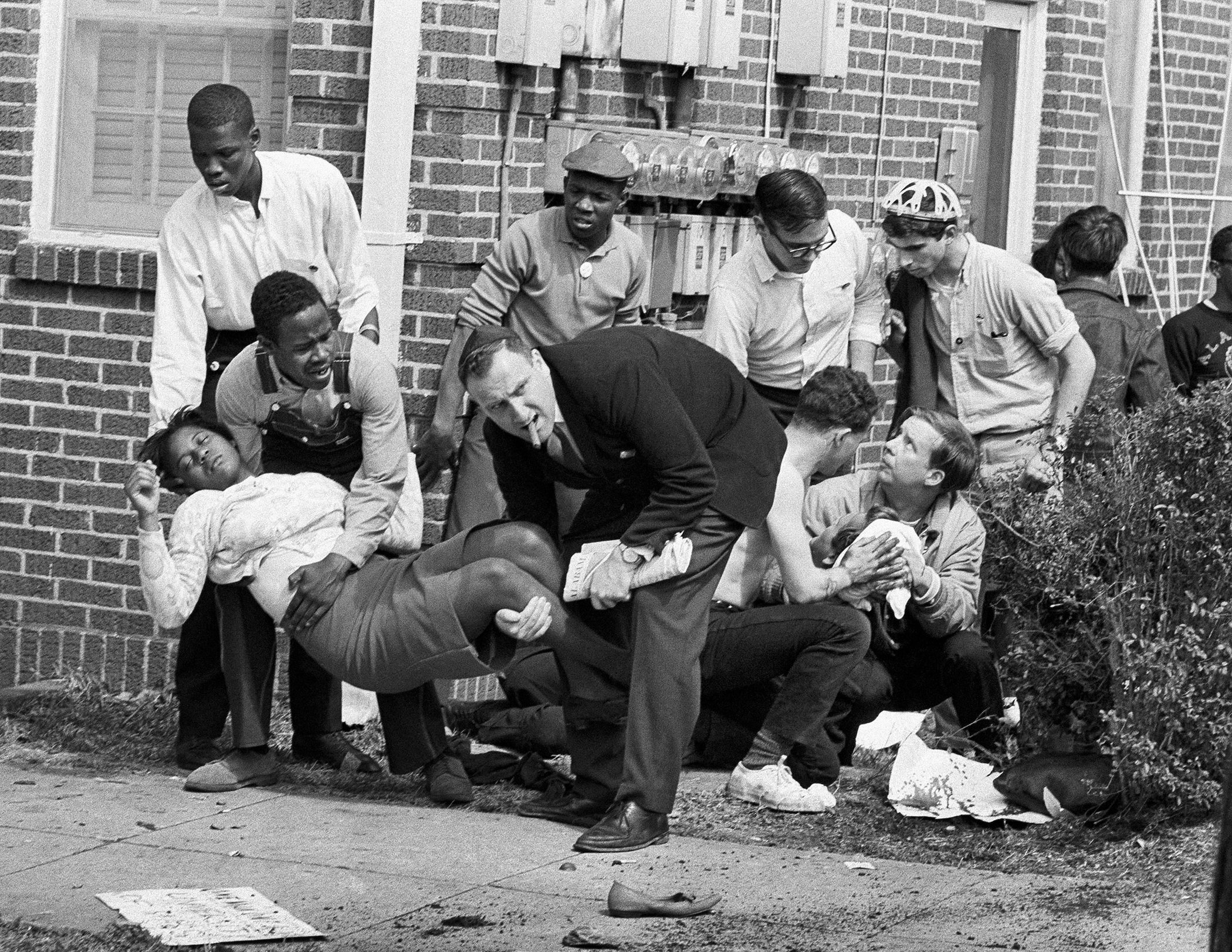 Amelia Boynton is carried while another injured man tended to after they were injured when state police as they broke up a demonstration march in Selma, Ala on March 7, 1965, widely known as "Bloody Sunday."