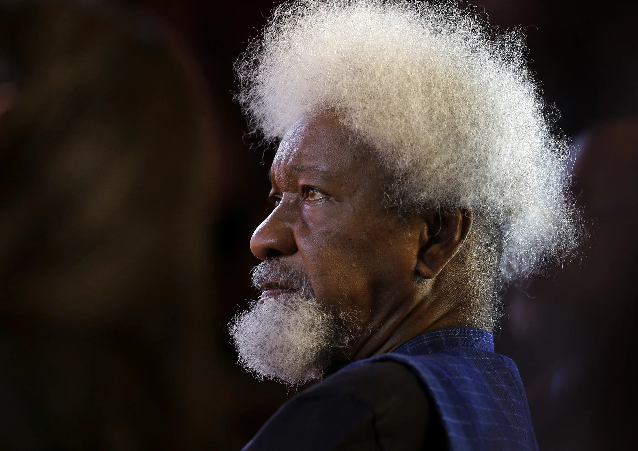 Nigerian playwright and poet Wole Soyinka, recipient of the 1986 Nobel Prize in Literature, listens during award ceremonies for the W.E.B. Du Bois Medal on the campus of Harvard University, in Cambridge, Mass., Oct. 2, 2013.