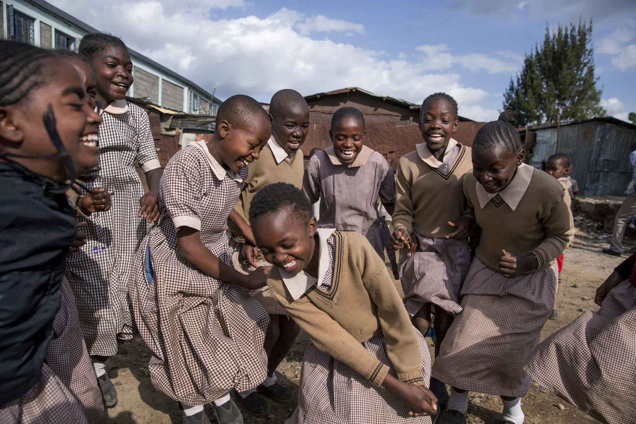 A group of girls laugh together in Korogocho slum, one of Nairobi's most populated informal settlements.