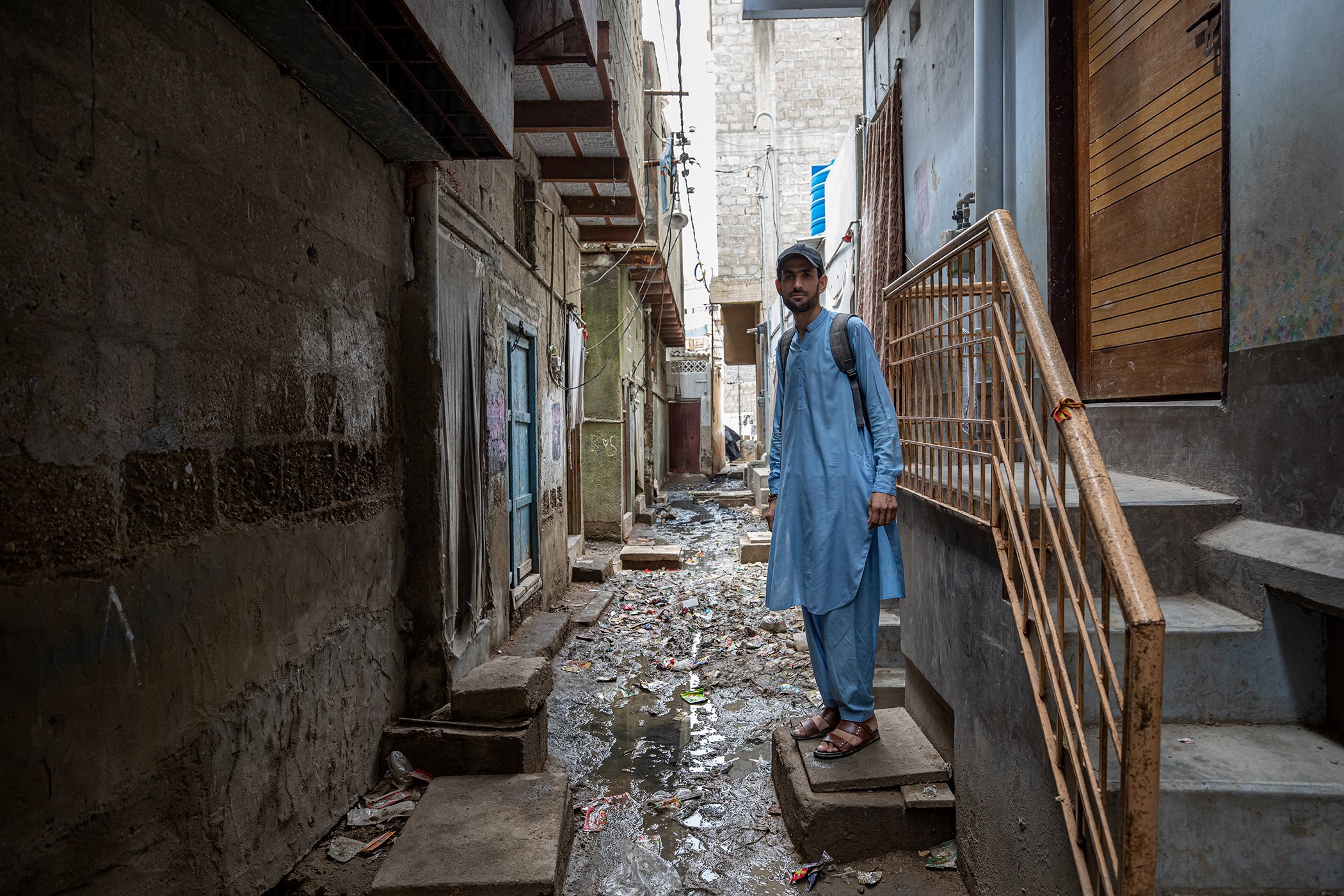 A polio vaccinator working in a high-risk, marginalized area where dirty water and sewerage acts as a breeding ground for poliovirus and other water-borne diseases in Sultanabad, Karachi, Pakistan on Aug. 21, 2022.