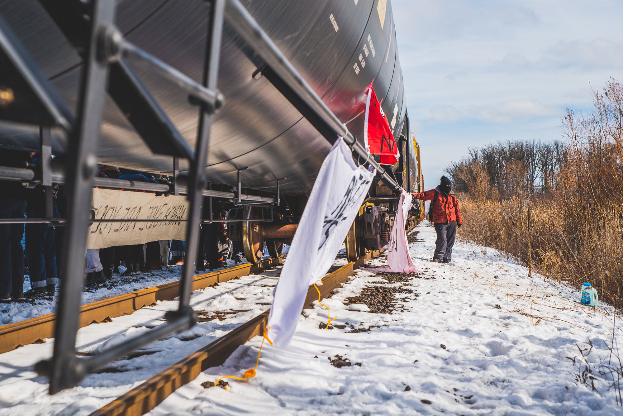 An organizer waits to help land defenders cross the tracks safely at a Wet'suwet'en Solidarity Event at the Rail Yard in Vaughan, Toronto, on Feb. 15, 2020.