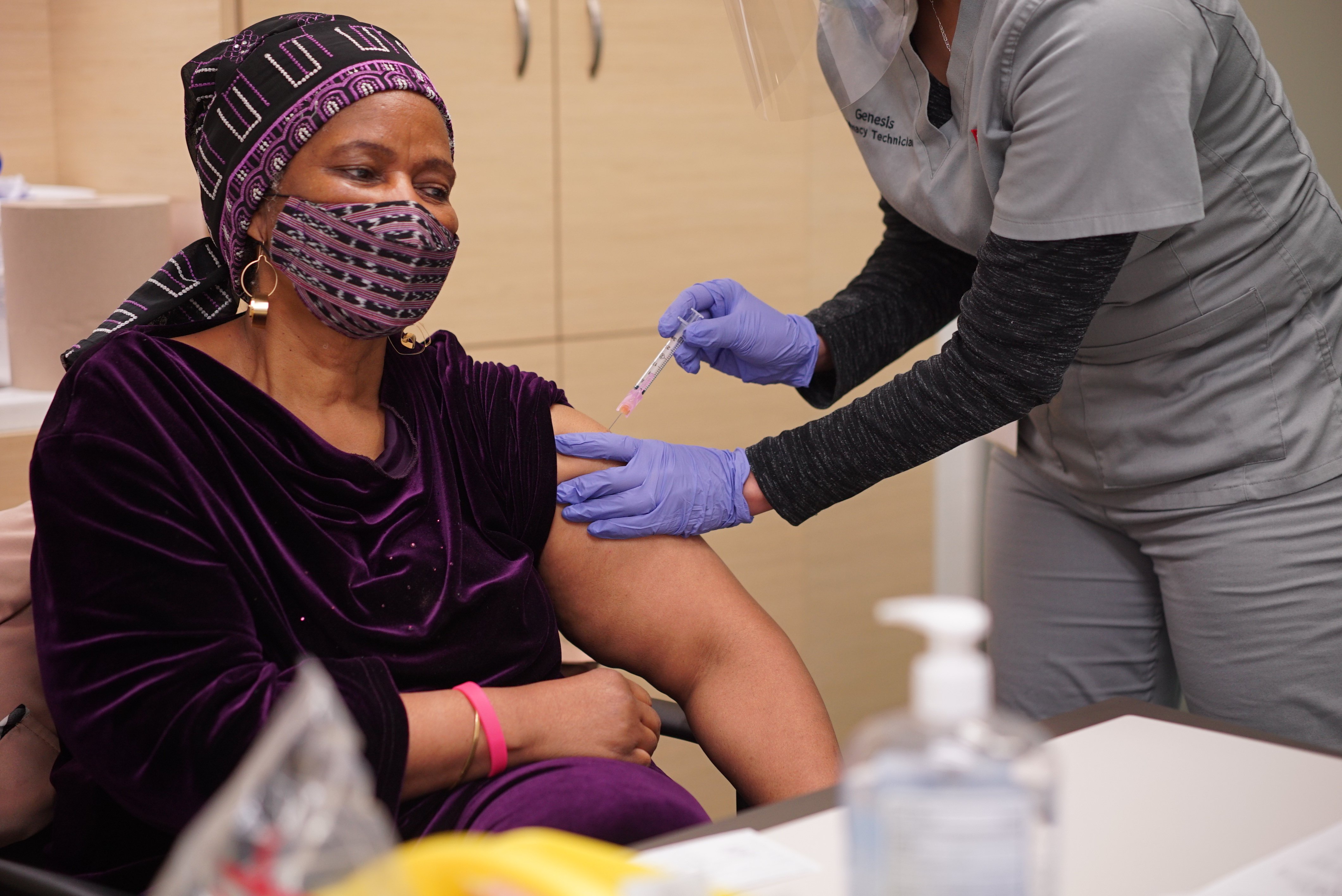 A nurse gives UN Women executive director, Phumzile Mlambo Ngcuka her first dose of the COVID-19 Vaccine.