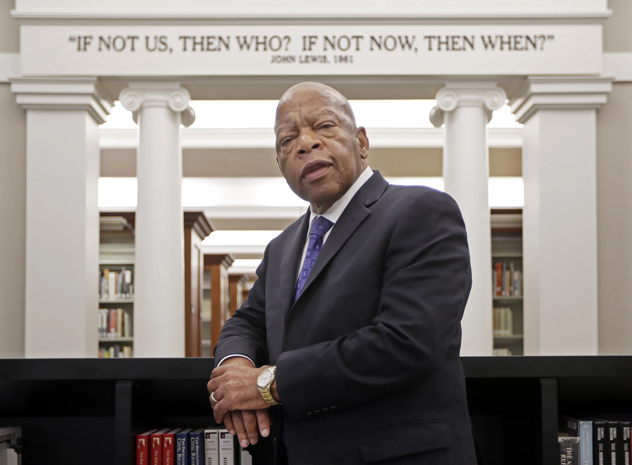 Rep. John Lewis, D-Ga., poses for a photograph under a quote of his that is displayed in the Civil Rights Room in the Nashville Public Library Friday, Nov. 18, 2016, in Nashville, Tennessee.