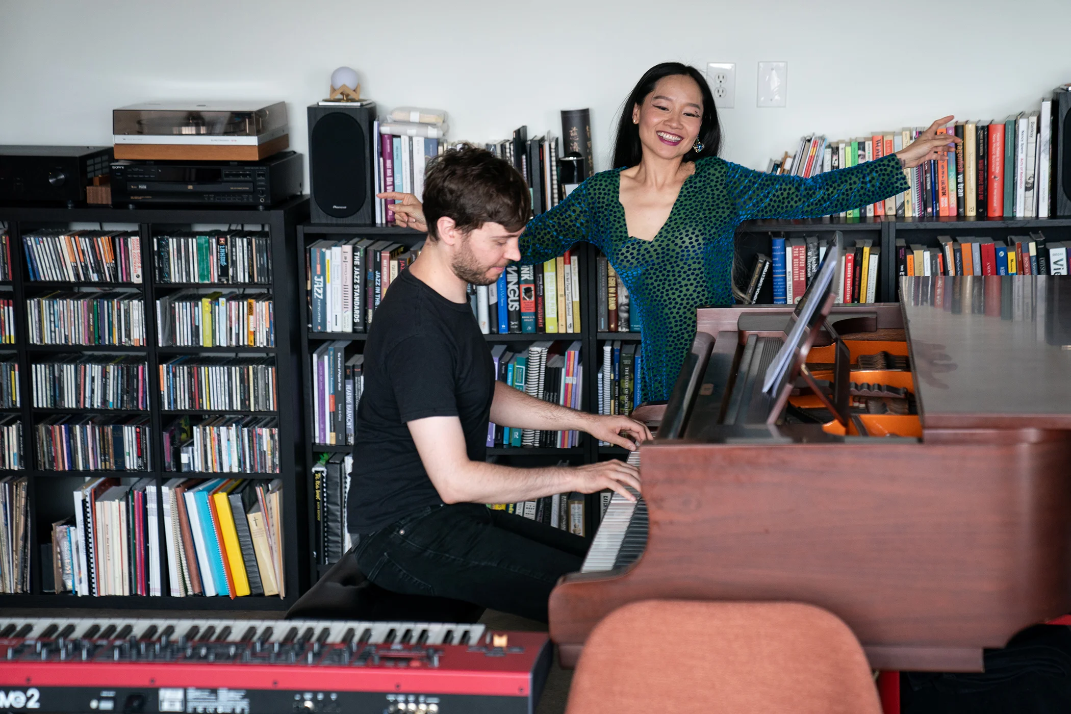 Mai Khôi and her husband Mark Micchelli perform a portion of their new show “The Immigrant Vegetable + Bad Activist” in their home in Philadelphia, Pa., on Aug. 12, 2026.