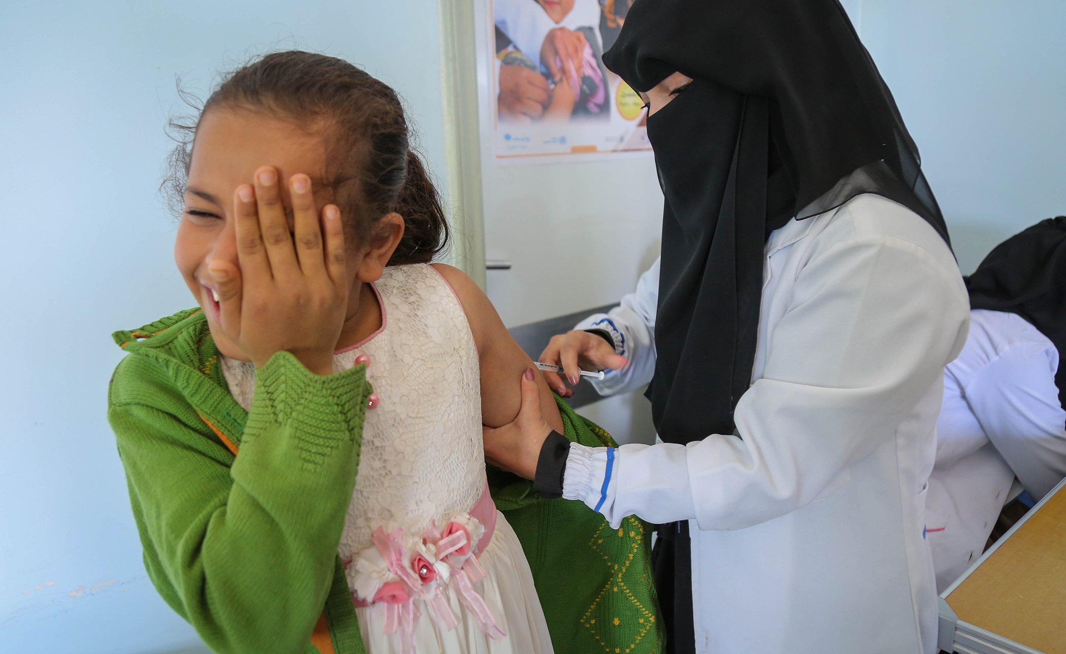 A child braces for a measles and rubella vaccination given by a local health worker through a UNICEF-backed campaign in Bani Alhareth, Sana’a, Yemen, on Feb. 9, 2019.