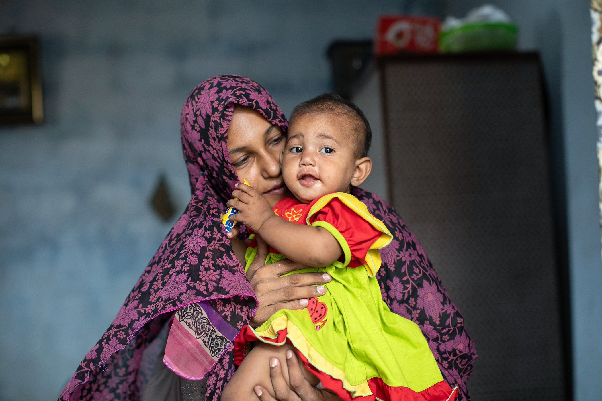 Sana, 29, is photographed with her 8-month-old daughter Amyra, at a community mobilizer's home in her neighborhood in Karachi, Pakistan on July 30, 2025.