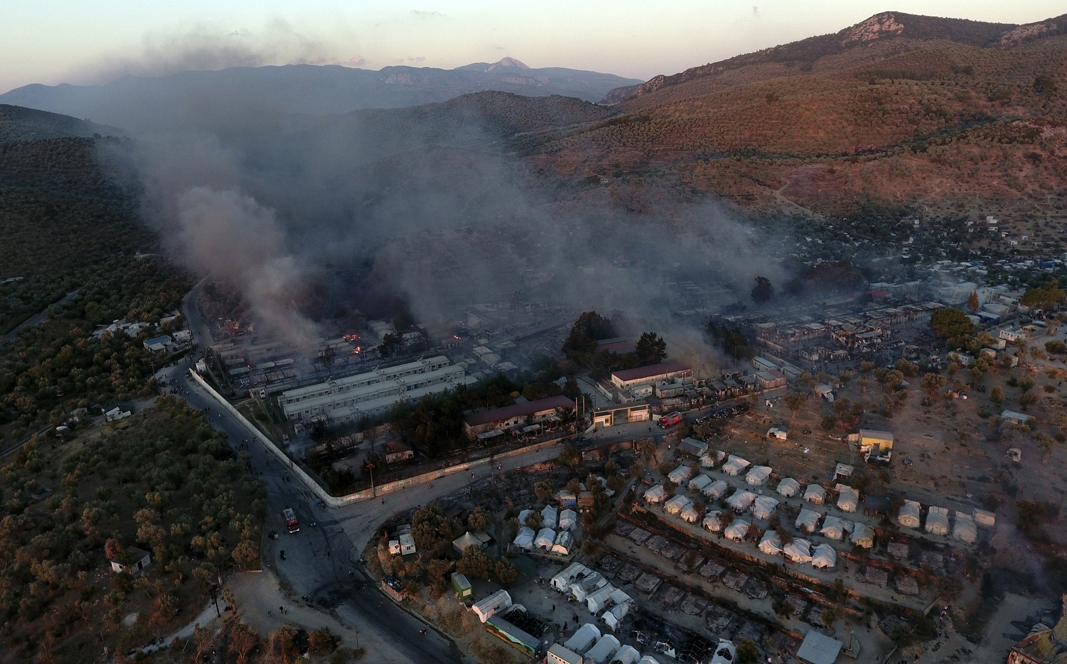 Fire burns container houses and tents in the Moria refugee camp on the northeastern Aegean island of Lesbos, Greece, on Sept. 9, 2020.