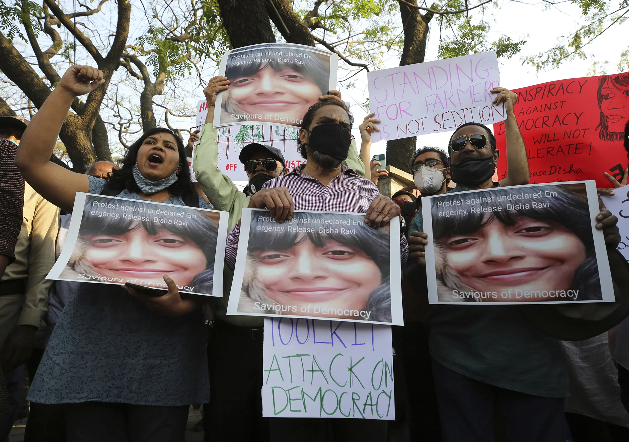 People shout slogans and hold placards demanding the release of Indian climate activist Disha Ravi, during a protest in Bengaluru, India, Feb.15 2021.