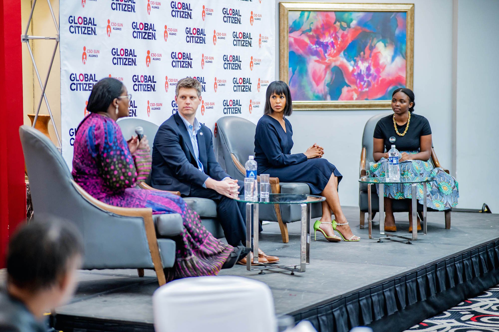 Global Citizen's Michael Sheldrick, Mwandwe Chileshe, and IFAD Goodwill Ambassador and Global Citizen board co-chair, Sabrina Elba speak at a panel at the civil society event in Zambia.