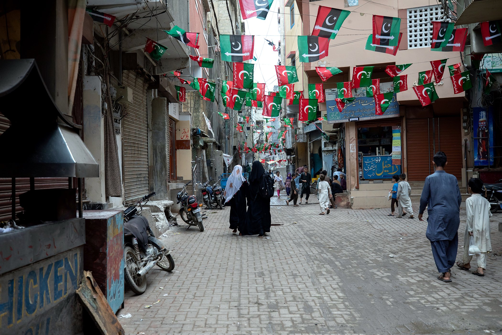 A polio vaccination team walks through the streets of their assigned community to ensure they have not missed any children at the end of a week-long vaccination drive in Sultanabad, Karachi, Pakistan on Aug. 21, 2022.