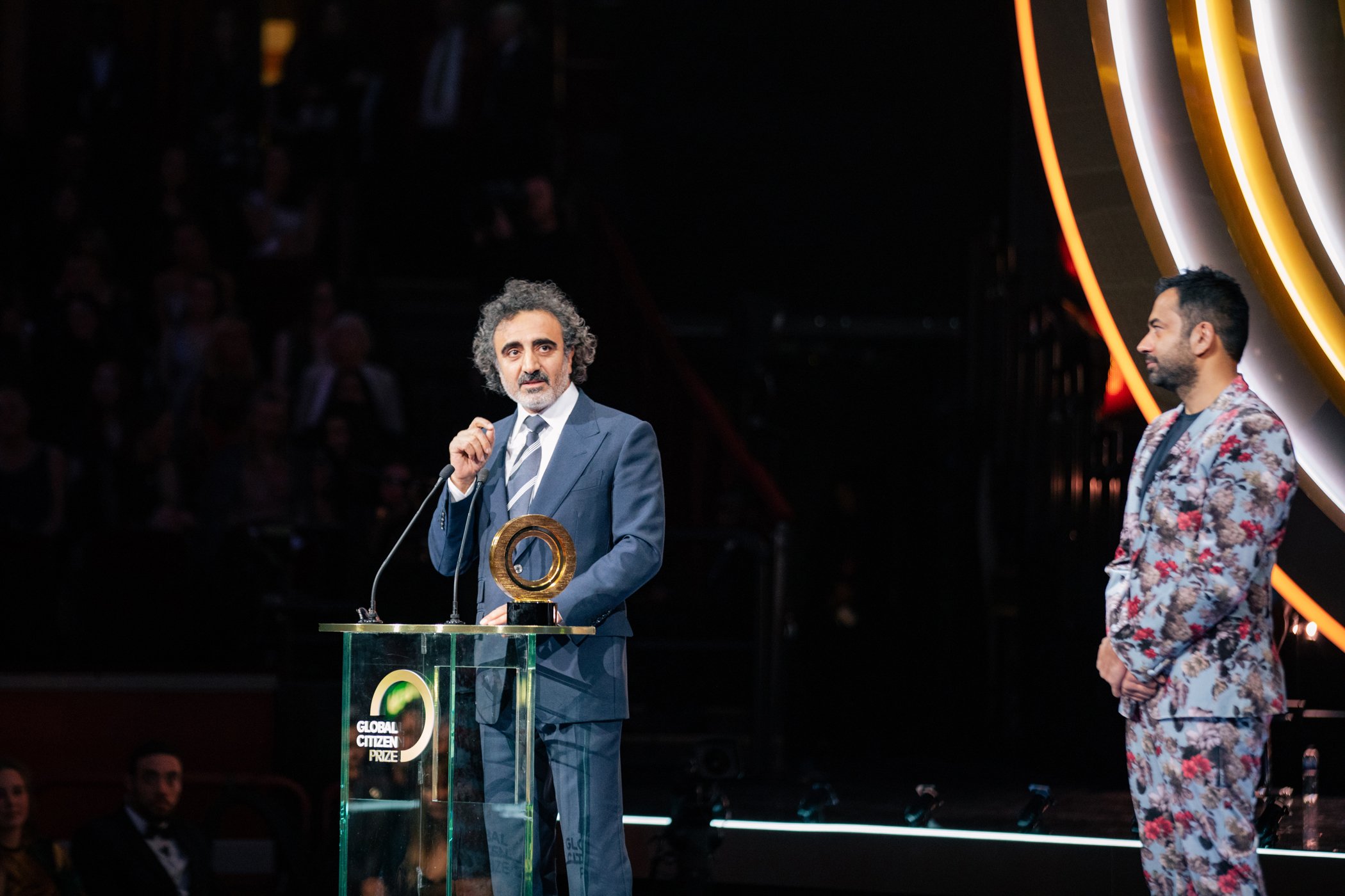 Hamdi Ulukaya and Kal Penn are seen on stage at the Global Citizen Prize at the Royal Albert Hall on Dec. 13, 2019 in London, England.