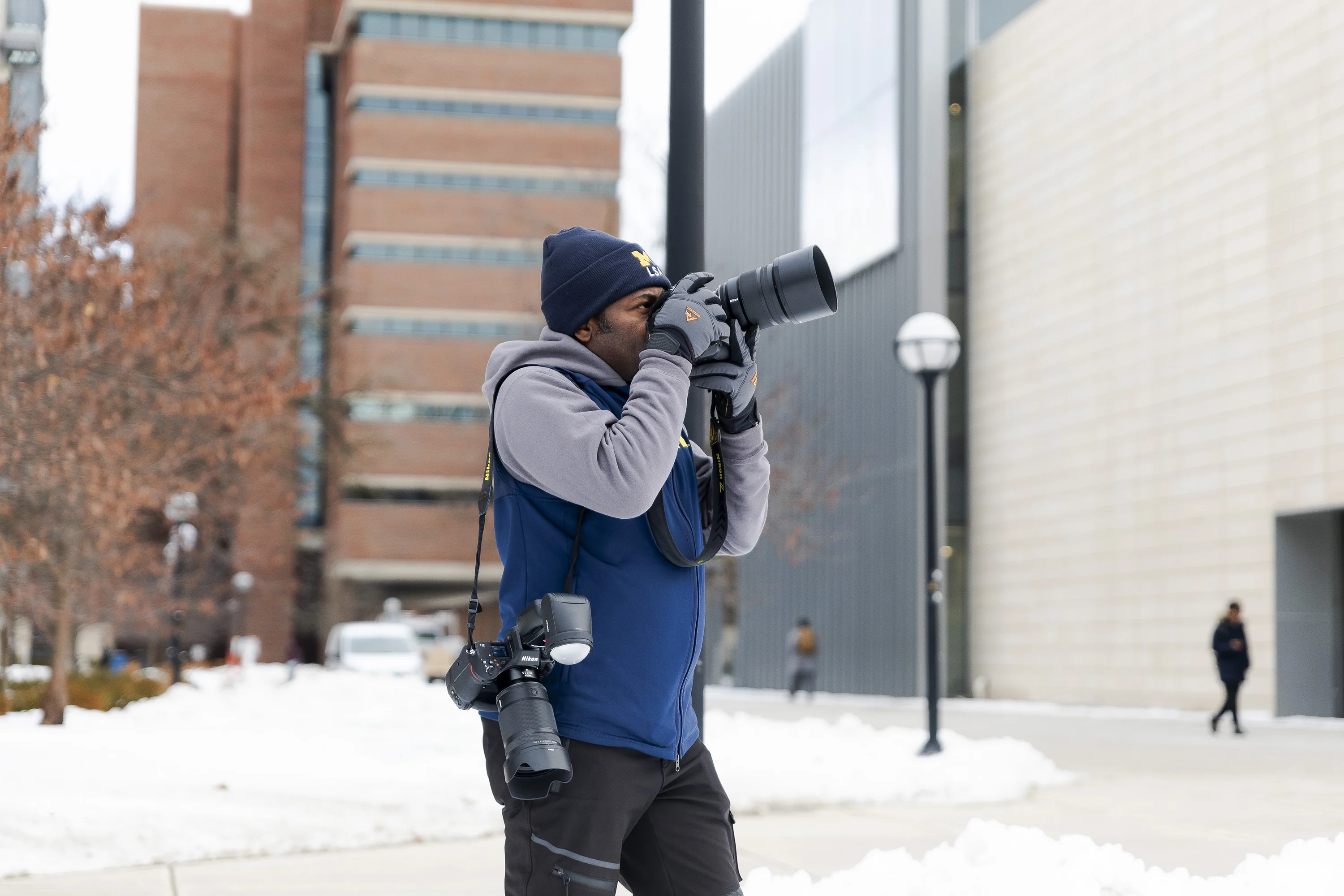 Photojournalist, Dieu-Nalio Chery, takes photos on campus for a “snow feature” assignment at the University of Michigan on Dec. 12, 2025 in Ann Arbor, Mich., where he now resides.