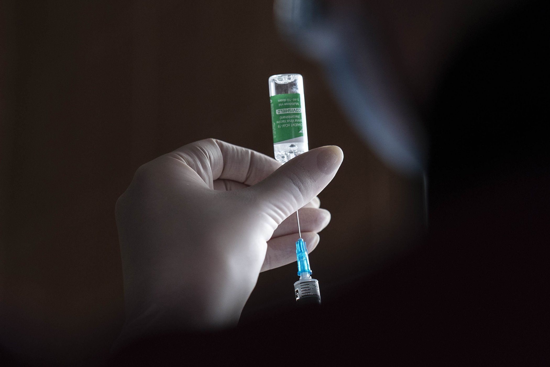 A medic prepares to administer a dose of an AstraZeneca COVID-19 vaccine at a military base in Kramatorsk, Ukraine, March 2, 2021.