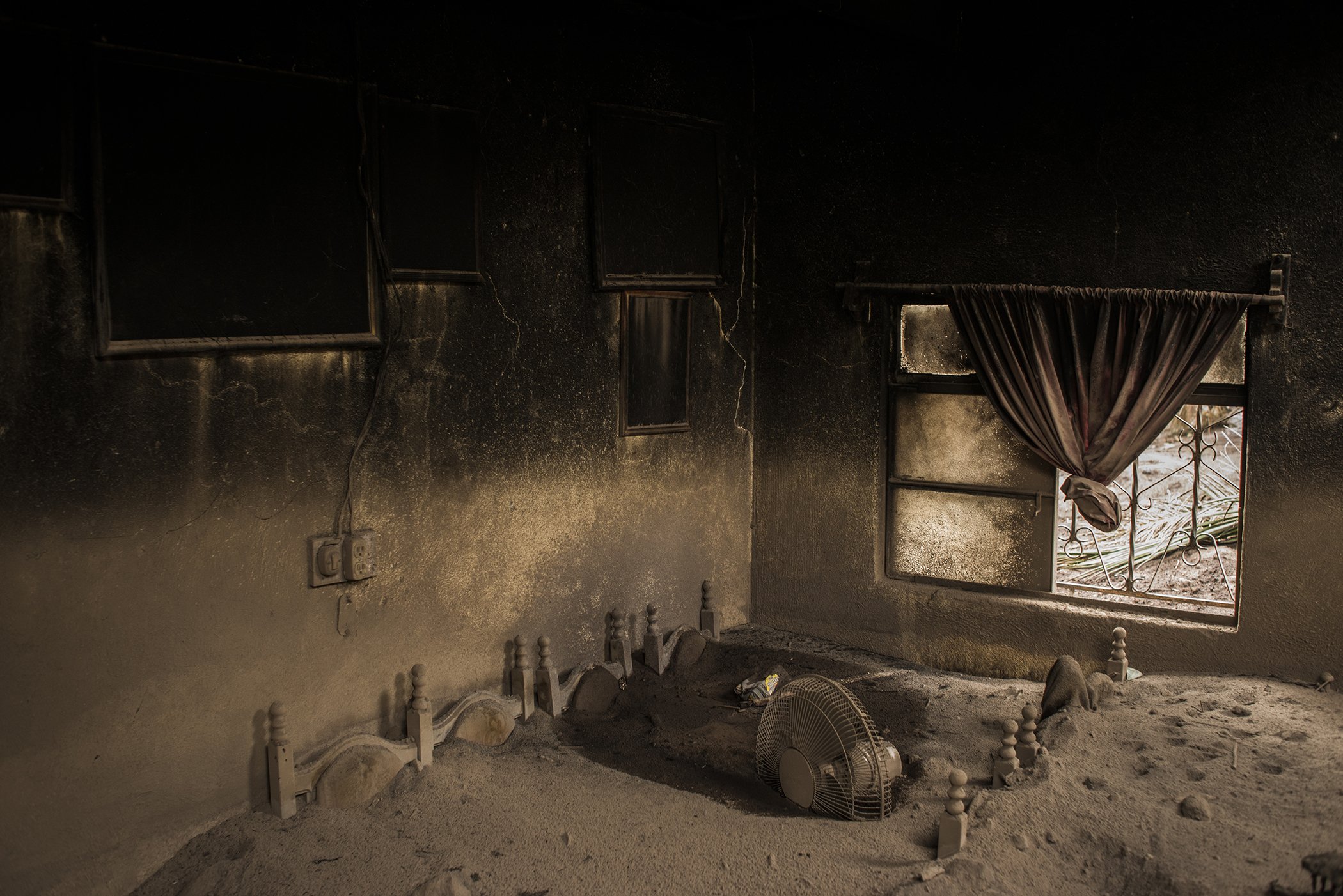 Still Life Volcano: The living-room of an abandoned home in San Miguel Los Lotes, Guatemala, lies covered in ash after the eruption of Volcán de Fuego on June 3, 2018. Nominated in the General News Singles category.