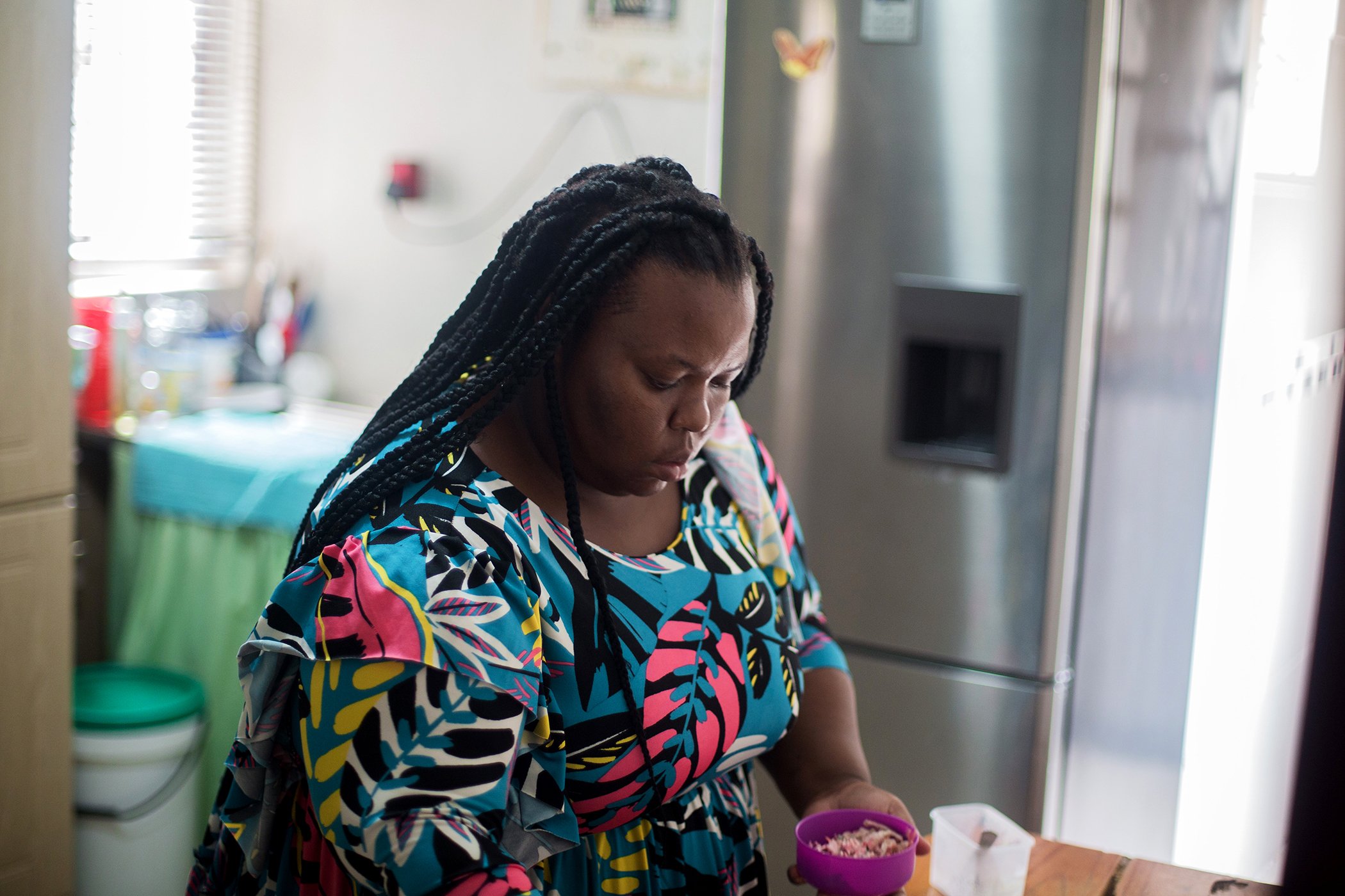 Noluthando Mhlongo prepares food that she will eat during her lunch break at Phoenix Community Health Centre in Phoenix, north of Durban on March 14, 2022.