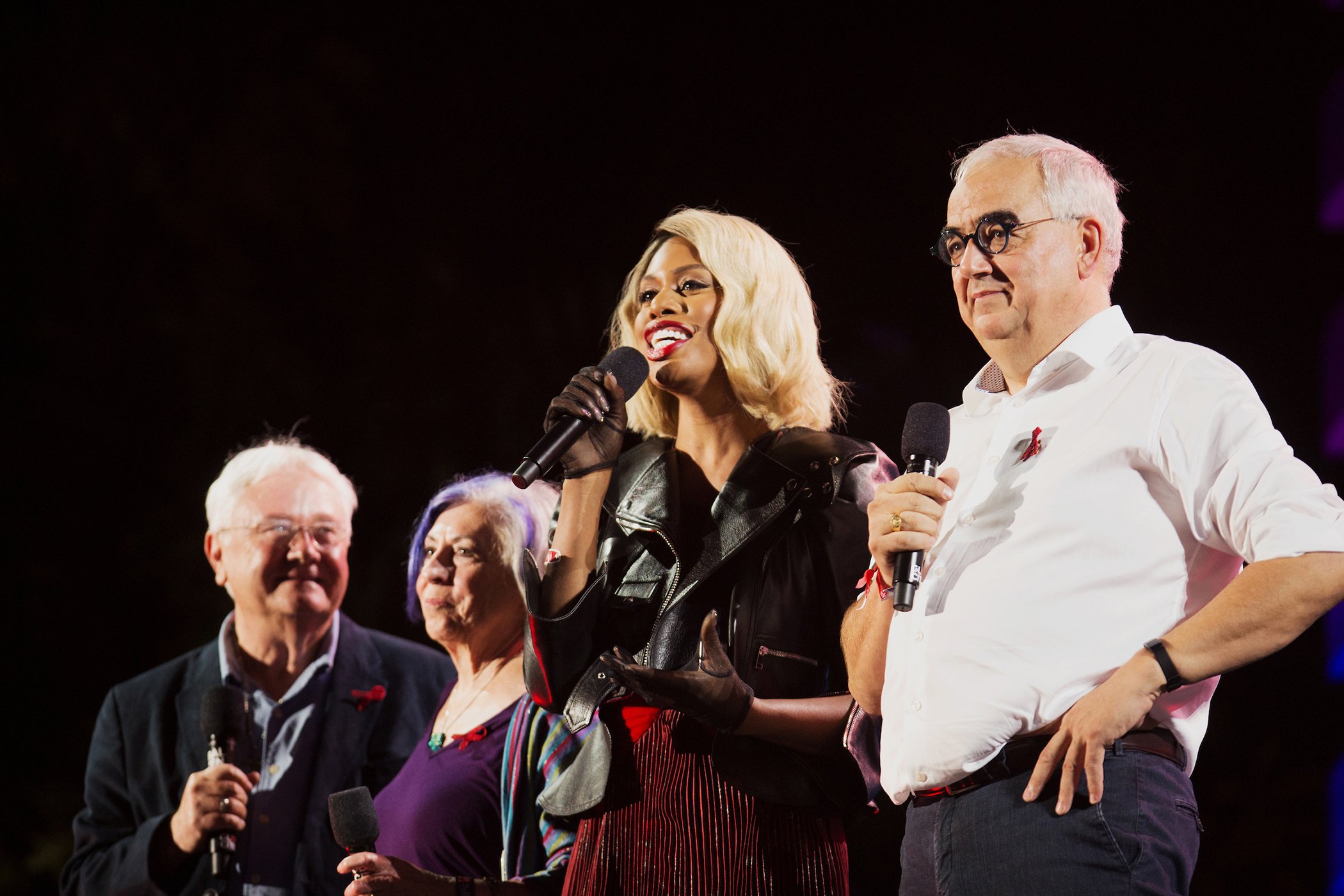 Laverne Cox (2nd R) speaks on stage with nurses Alison Mood and Cliff Morrison from Ward 5B, the first ward in the US dedicated to AIDS patients in 1983, and Dr. Paul Stoffels, who announced that Johnson & Johnson will commence an HIV vaccine study.