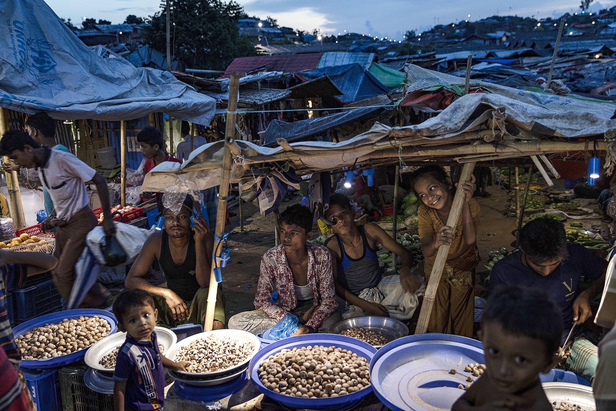 Women and men buy and sell food and other good at the Kutupalong-Balukhali mega-camp, Cox's Bazar on June 24, 2019.