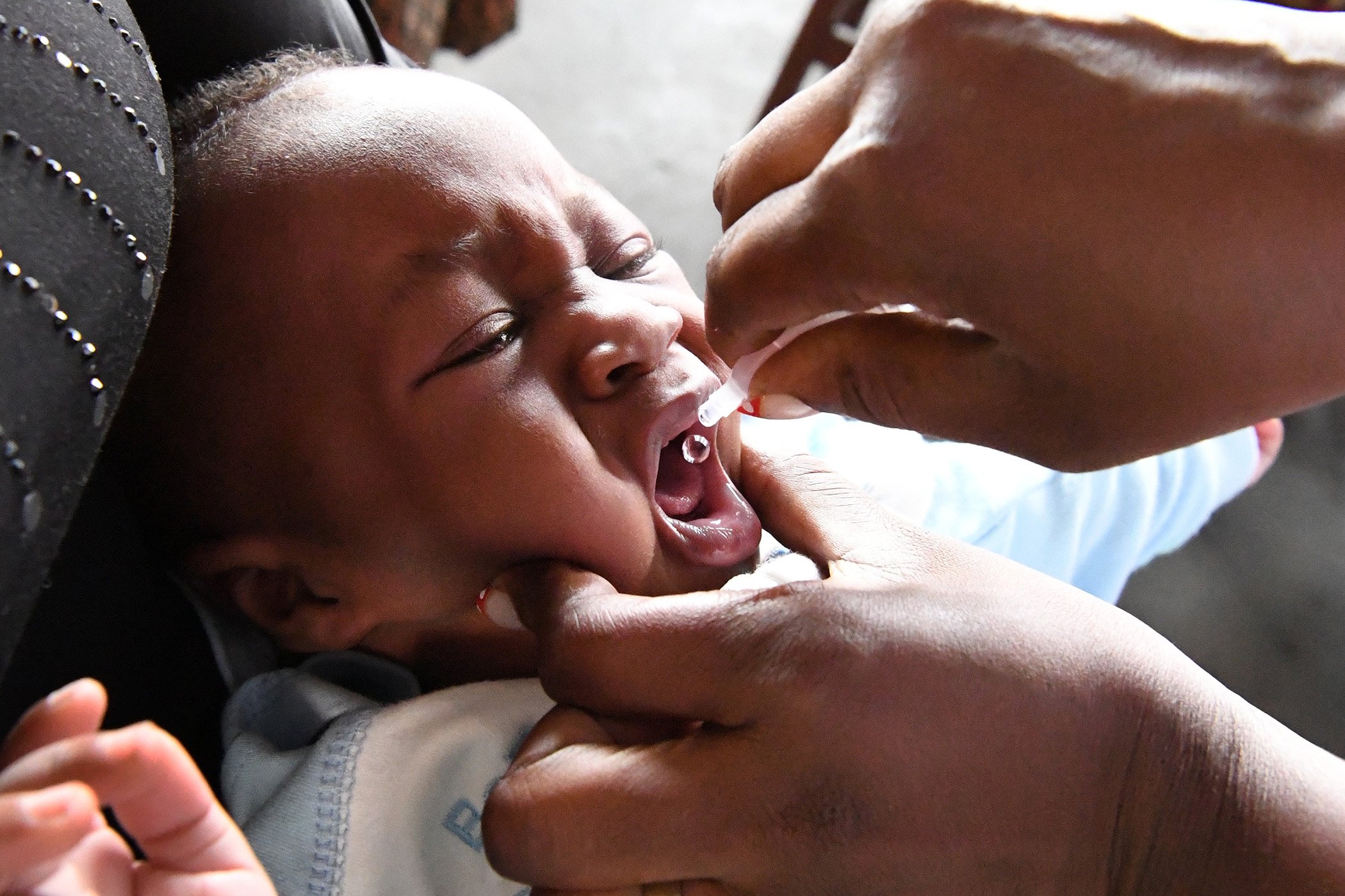 A baby is being vaccinated and weighed at the health center of Brazzaville, the capital of Congo.