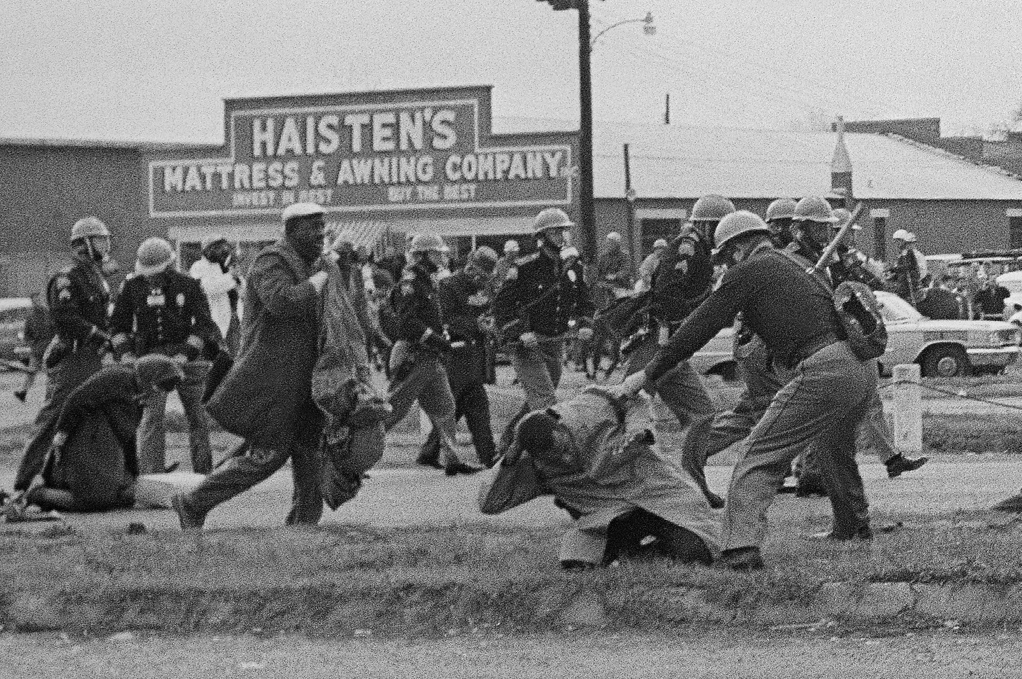 State troopers swing billy clubs to break up a civil rights voting march in Selma, Alabama, March 7, 1965. John Lewis, chairman of the Student Nonviolent Coordinating Committee (in the foreground) is pictured as he is beaten by a state trooper.
