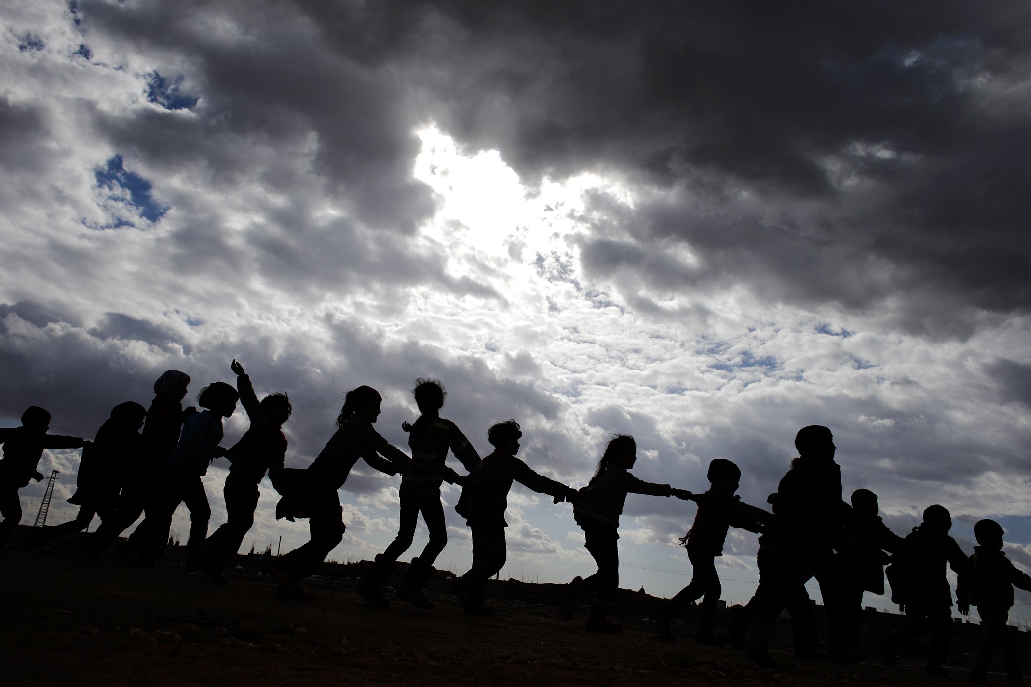 Syrian children, who were displaced with their families from eastern Aleppo, play in the village of Jibreen south of Aleppo, Syria in December 2016.