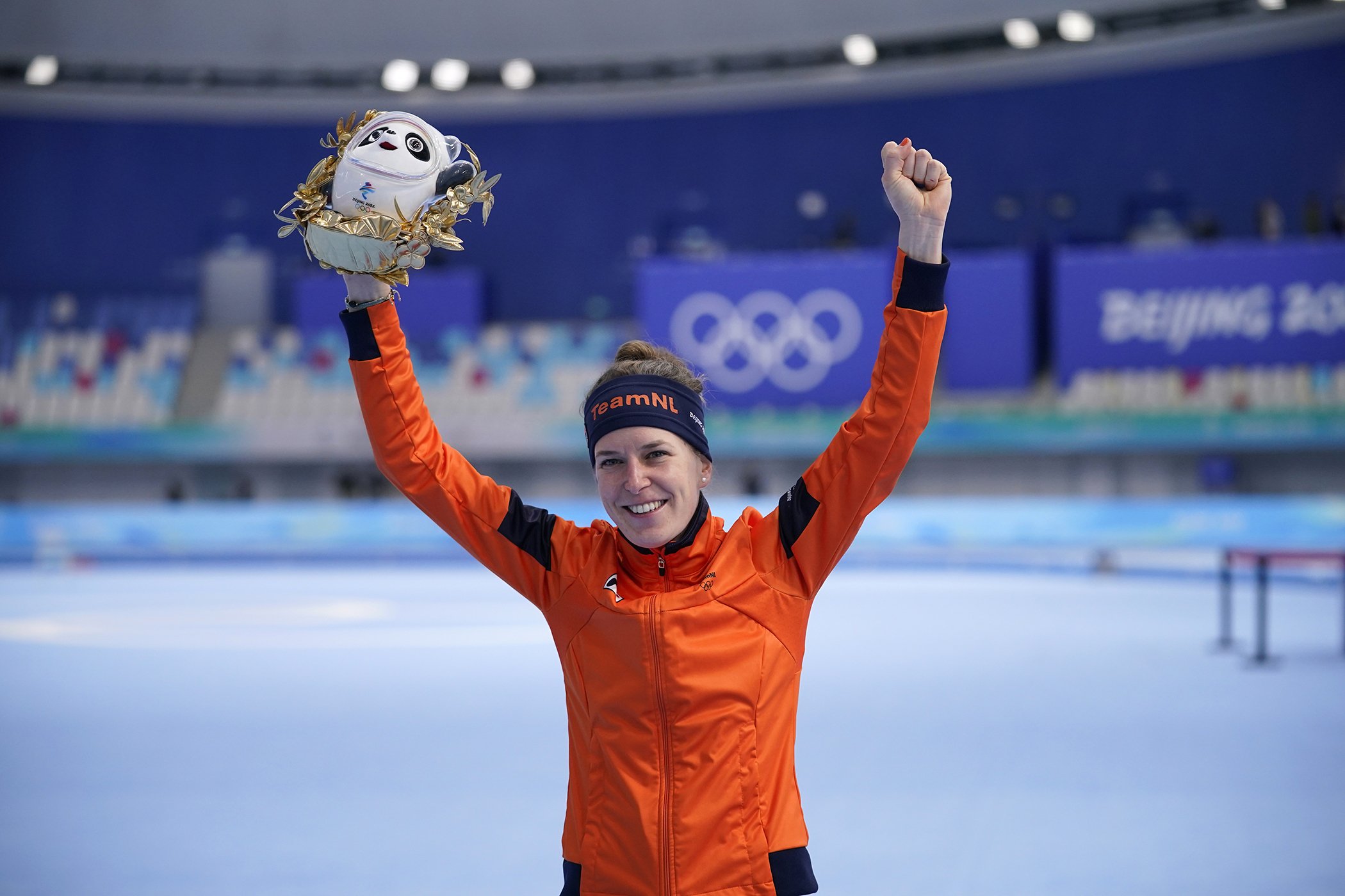 Ireen Wust of the Netherlands reacts during a flower ceremony after winning the gold medal and setting an Olympic record in the women's speedskating 1,500-meter race at the 2022 Winter Olympics, Feb. 7, 2022, in Beijing.
