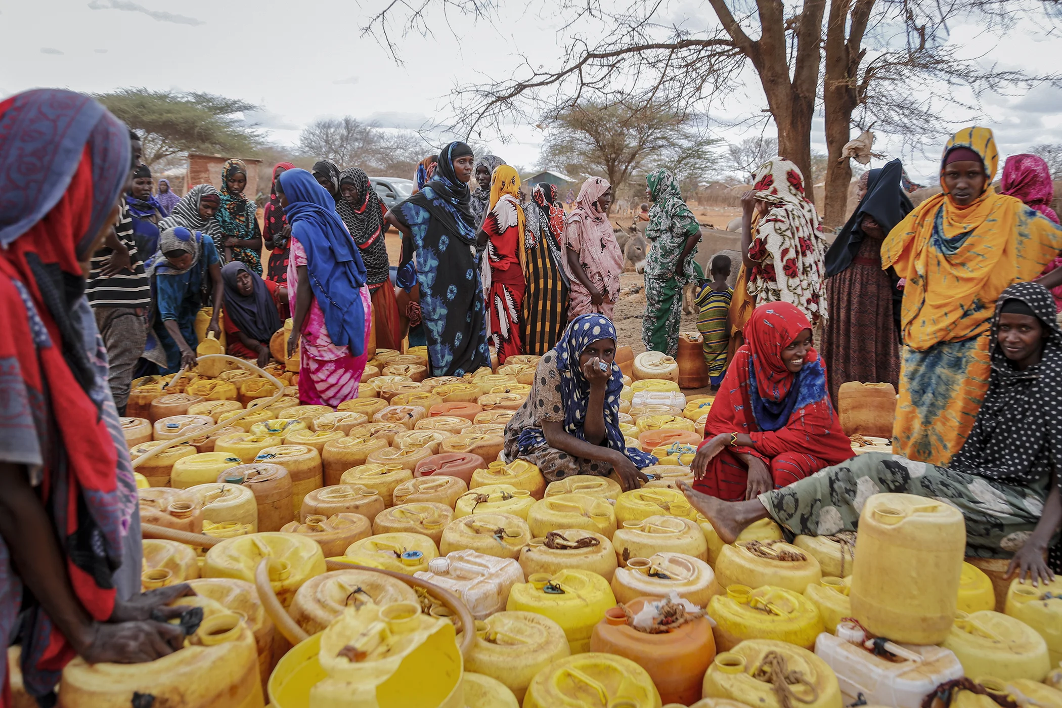 Kenyan women of Somali origin wait with their containers for a water distribution from the government near Kuruti, in Garissa County, Kenya, Oct. 27, 2021.