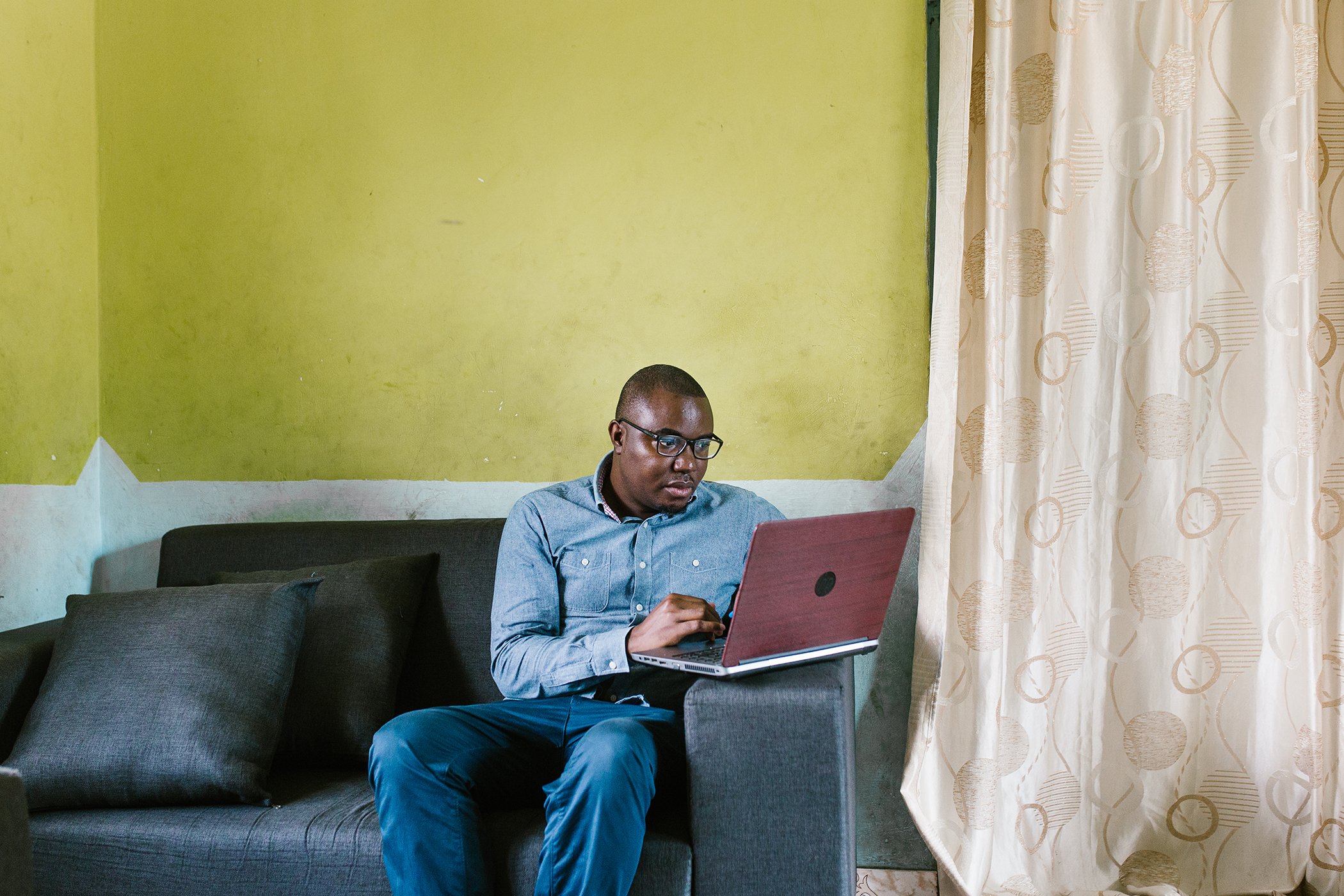 Joachim Mabula works on his computer at home in Tanga, Tanzania on Dec. 5, 2020. From creating a medical dictionary to diagnosing people through Twitter, Mabula is making health information accessible for the 100 million Swahili speakers in East Africa.