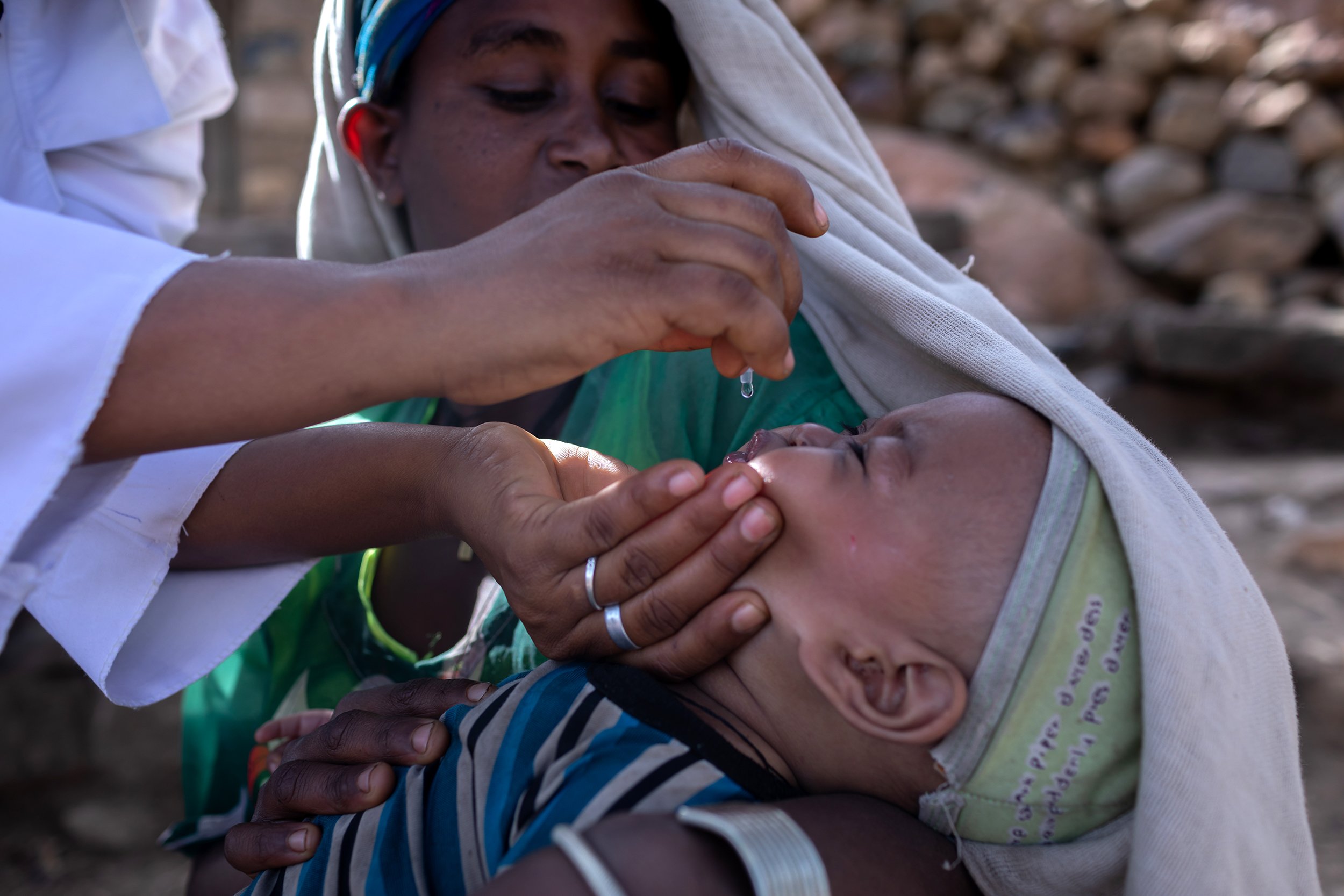 Tsehaynesh Azagne brings her 9-month-old baby for his vaccine at a UNICEF-supported vaccination campaign in areas affected by conflict in the Waghimra zone in May 2022.