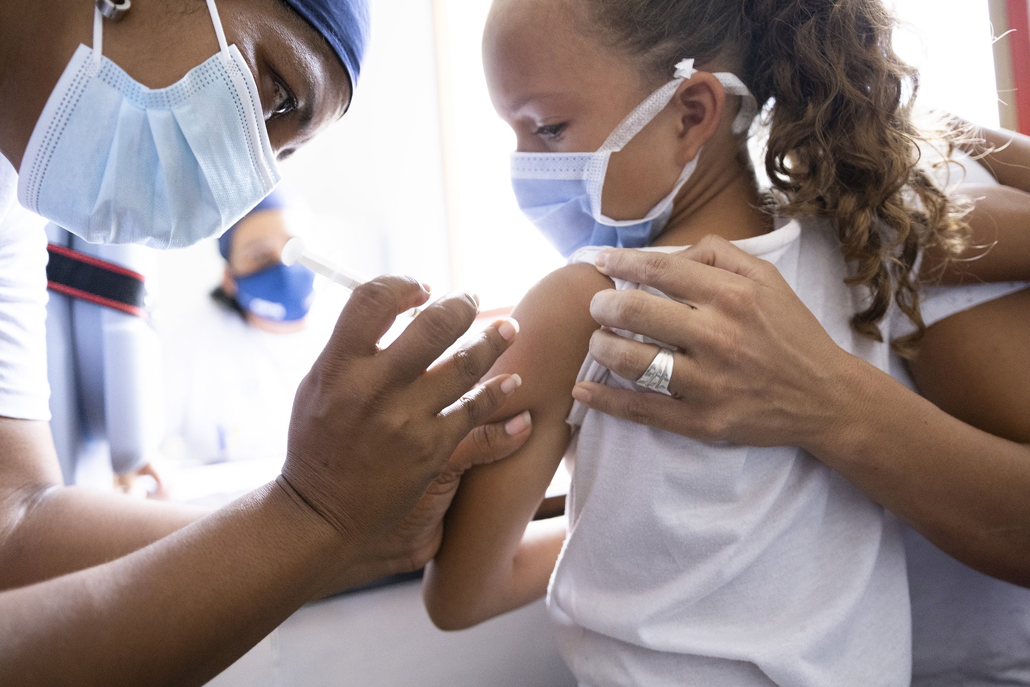 Karla Flores, 7, is vaccinated during a mass vaccination day in San Vicente community, Miranda state, Venezuela on Sept. 3, 2021.