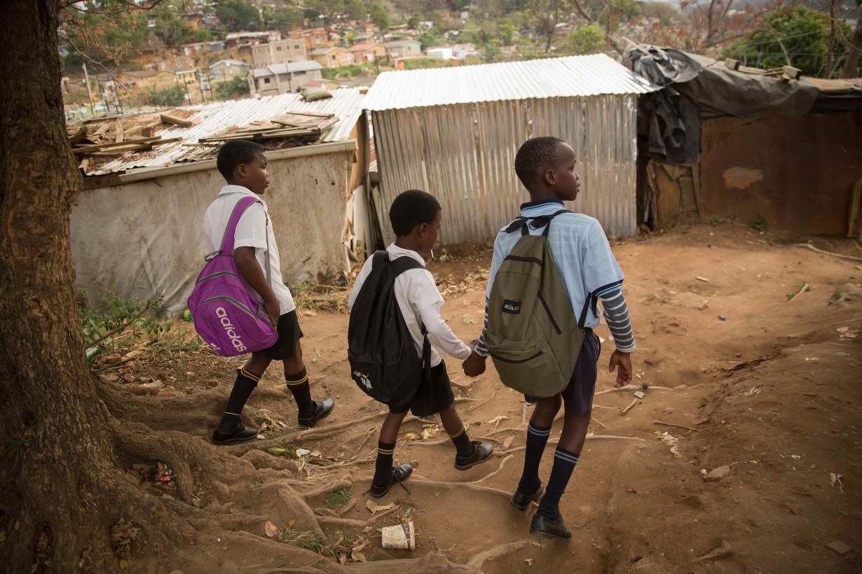 A group of children return home from school in the Durban informal settlement of Cato Crest, South Africa, August 16, 2018.