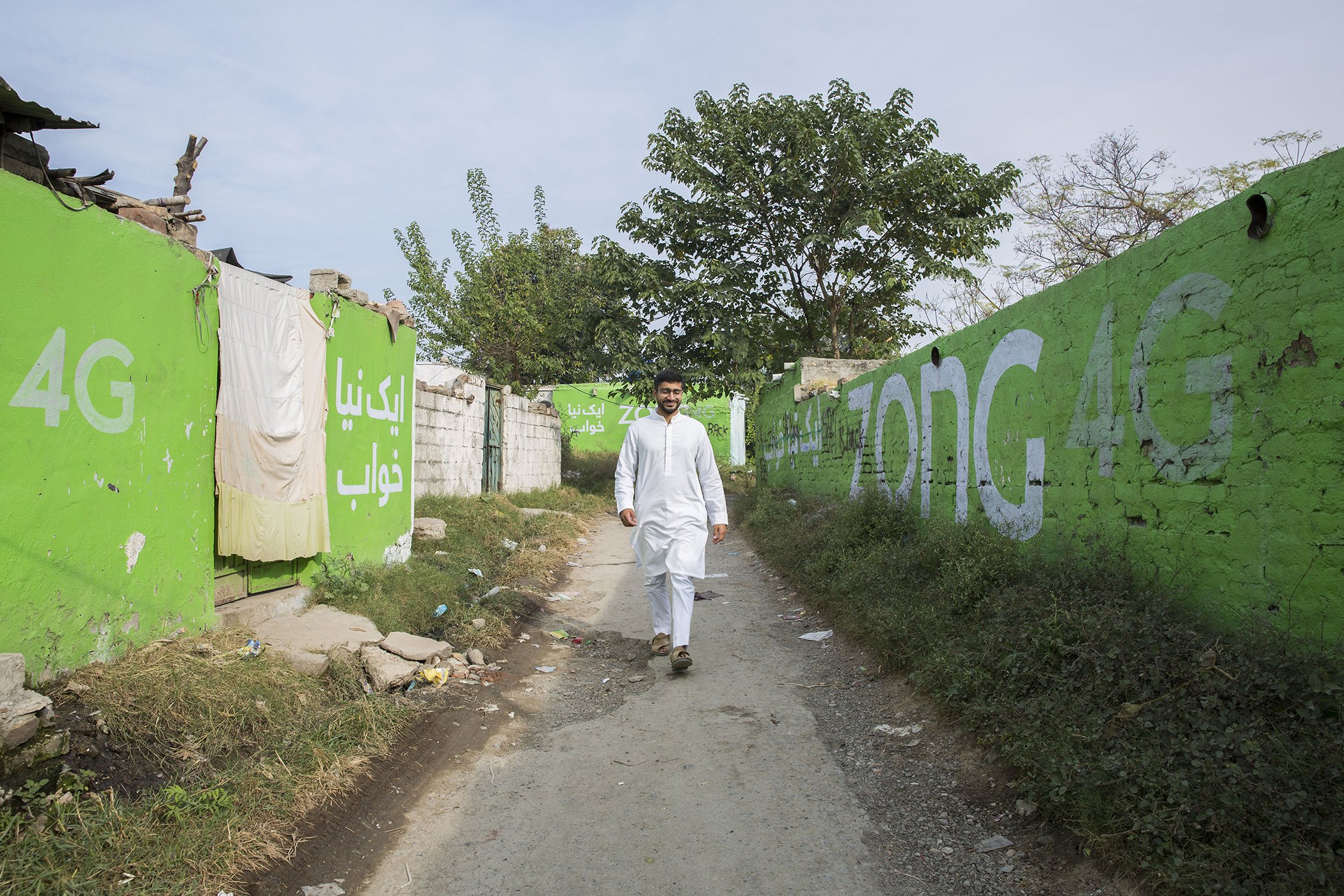Haroon Yasin roams the streets of Bheka Saiyidaan, a slum where he built his first school, in Islamabad, Pakistan on Nov. 14, 2019.