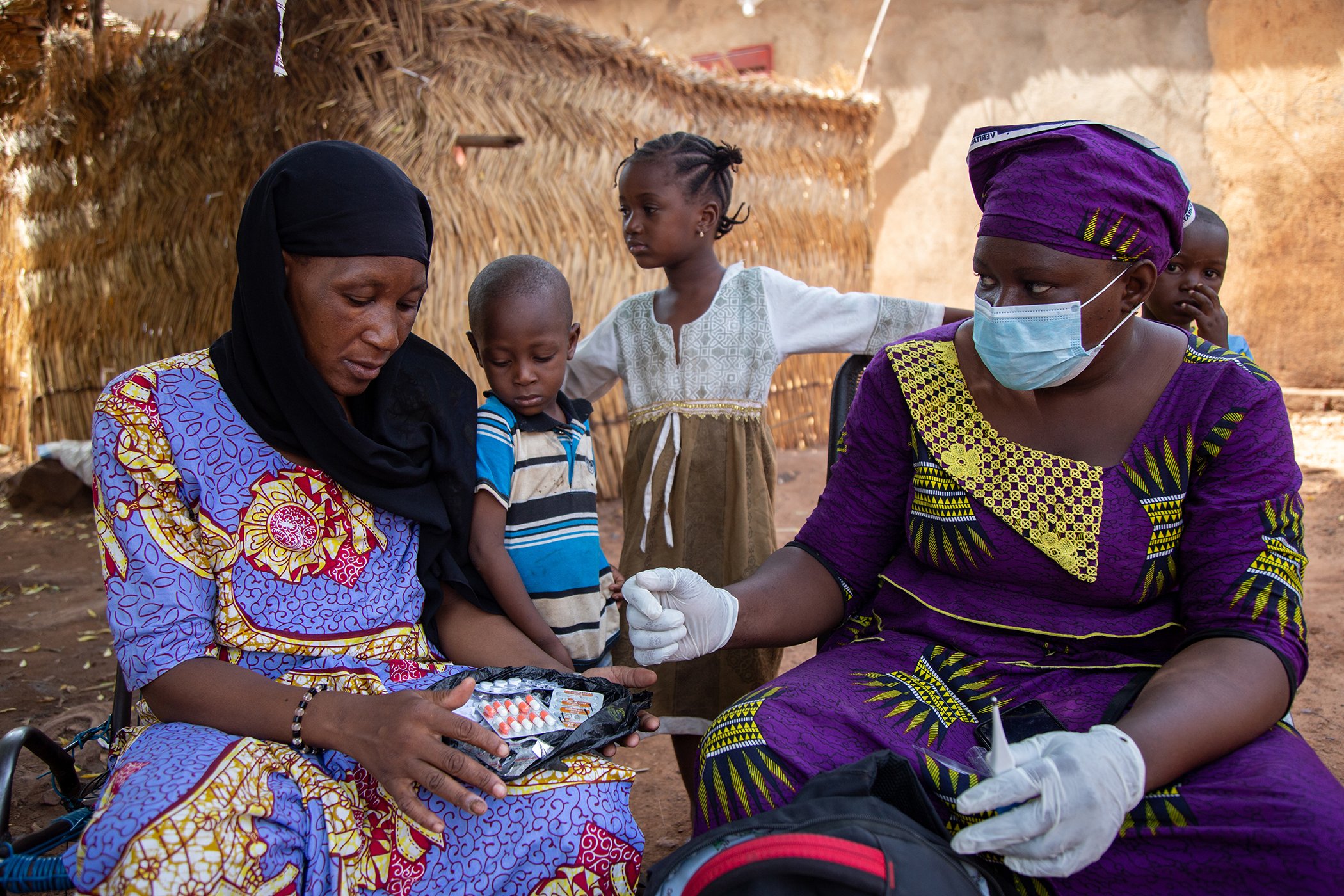 Community health worker Adele Coulibaly follows up with Mariame Coulibaly who was recently treated for an illness, during rounds to speak with families in her area of Yirimadio about malaria prevention on July 2, 2020 in Bamako, Mali.
