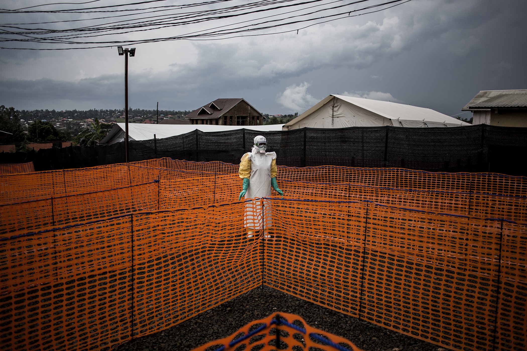 Fighting Ebola and Conflict: A health worker waits to handle an unconfirmed case of Ebola at a newly built treatment centre in Bunia, 200 km north of Beni, on Nov. 7, 2018. Nominated in the General News Stories category.