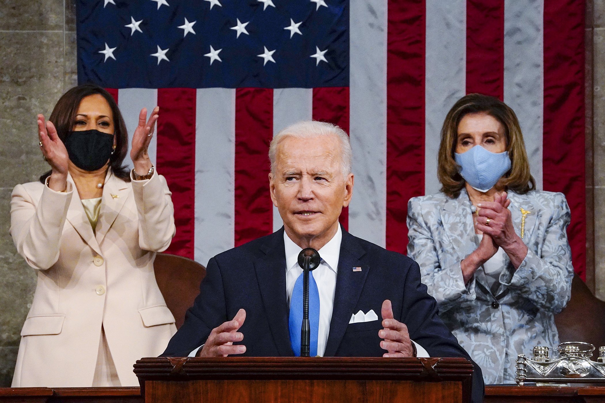 President Joe Biden addresses a joint session of Congress, April 28, 2021, in the House Chamber at the U.S. Capitol in Washington, as Vice President Kamala Harris, left, and House Speaker Nancy Pelosi of Calif., are pictured behind him.