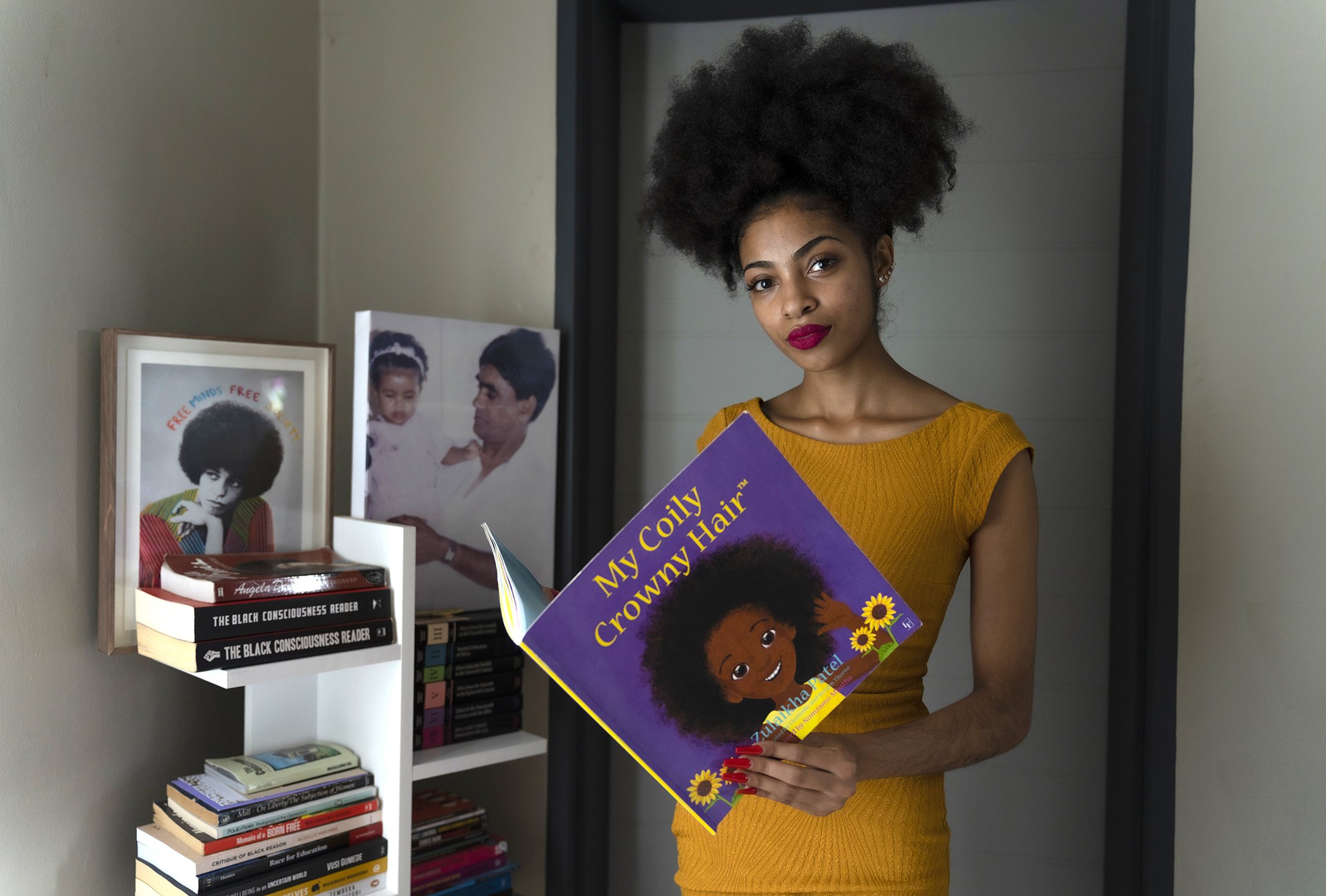 Zulaikha Patel poses for a portrait with a copy of her children’s book “My Coily Crowny Hair” at her home in Midrand, South Africa in January 2023.