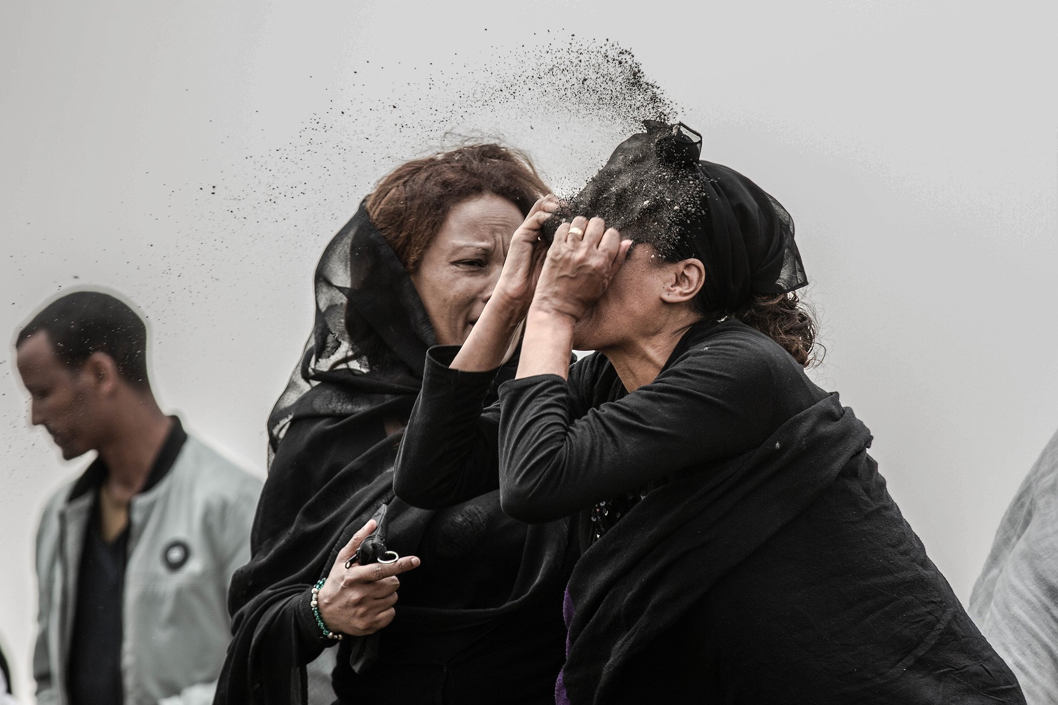 A relative of a victim of the crash of Ethiopian Airlines Flight ET302 throws dirt in her face as she grieves at the scene where the Boeing 737 Max 8 crashed shortly after takeoff on Sunday killing all 157 outside Addis Ababa, Ethiopia, on March 14, 2019.