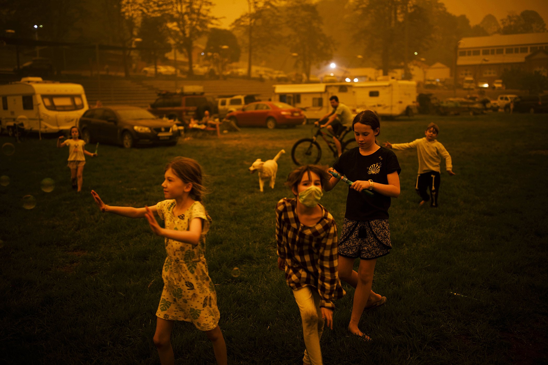 Bushfire Evacuation Center: Abigail Ferris, center, plays with friends at a temporary evacuation center in New South Wales, Australia, Dec. 31, 2019. Nominated in the contemporary issues singles category.