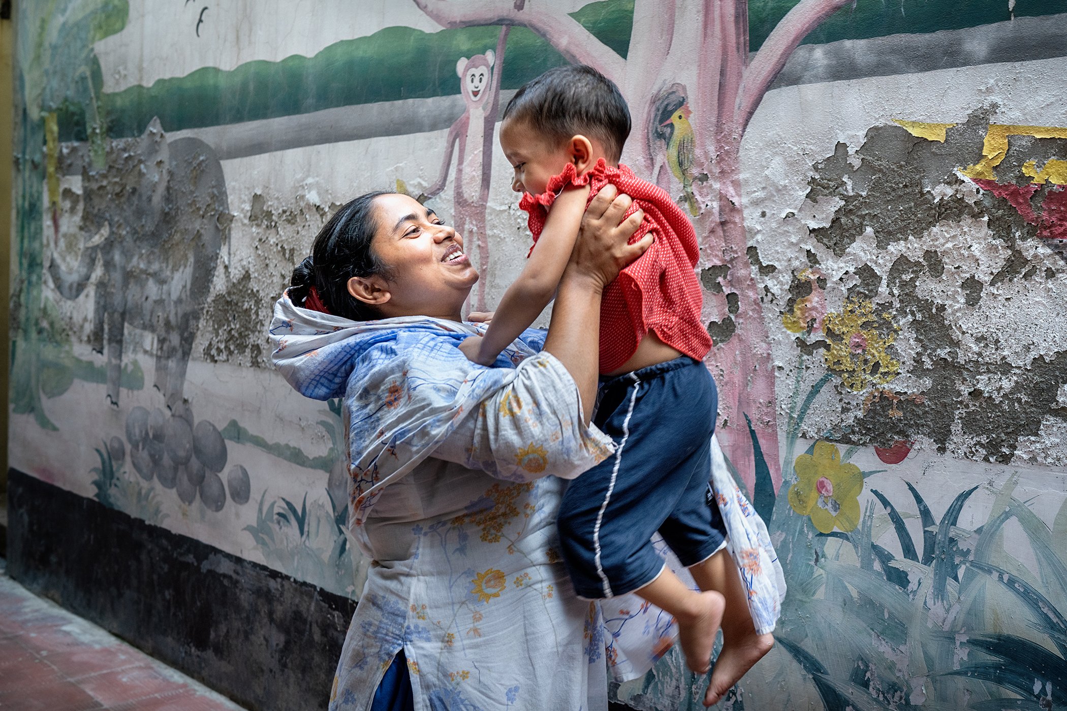 Shapla picks up her daughter Cynthia from the child care center of Evince Garments Limited in Dhaka, Bangladesh.