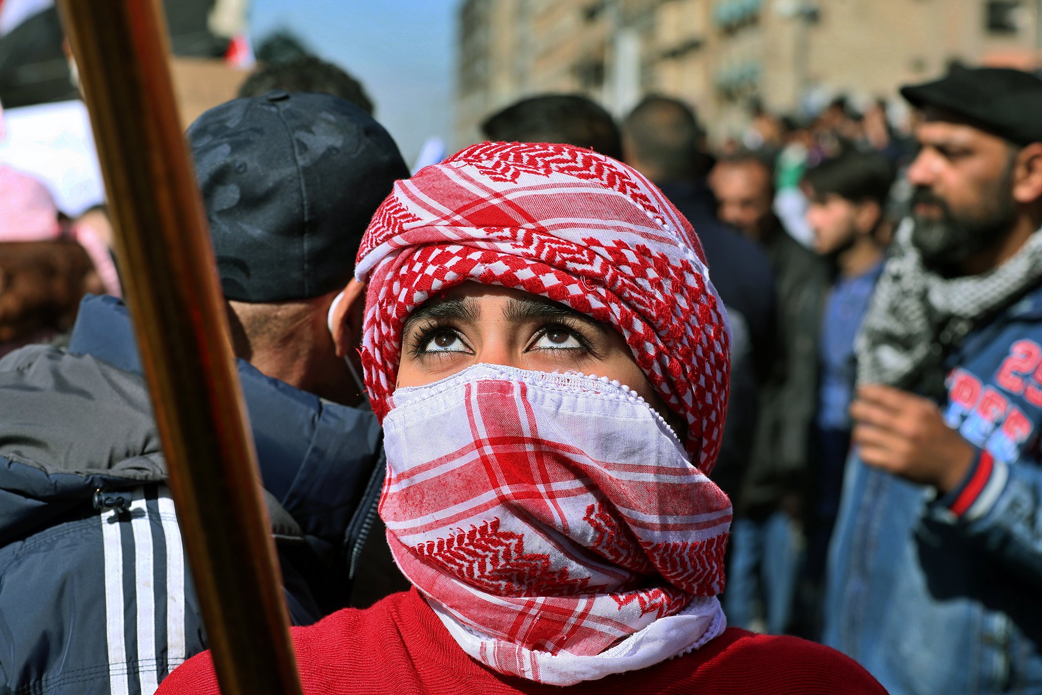 A woman waves an Iraqi flag during a protest in Tahrir Square, Baghdad, Iraq, Feb. 13, 2020.