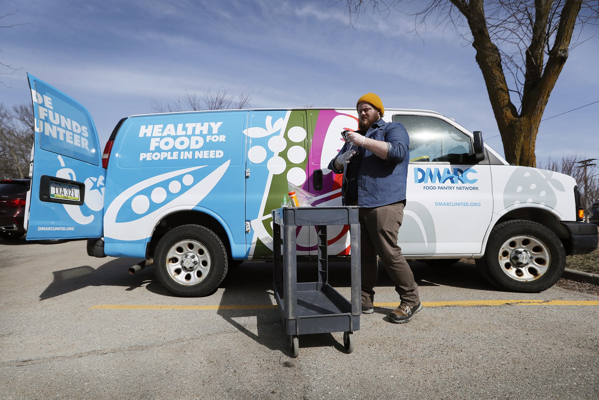 Des Moines Area Religious Council food pantry worker Patrick Minor prepares to pass out food at a senior center in Des Moines, Iowa on March 17, 2020.