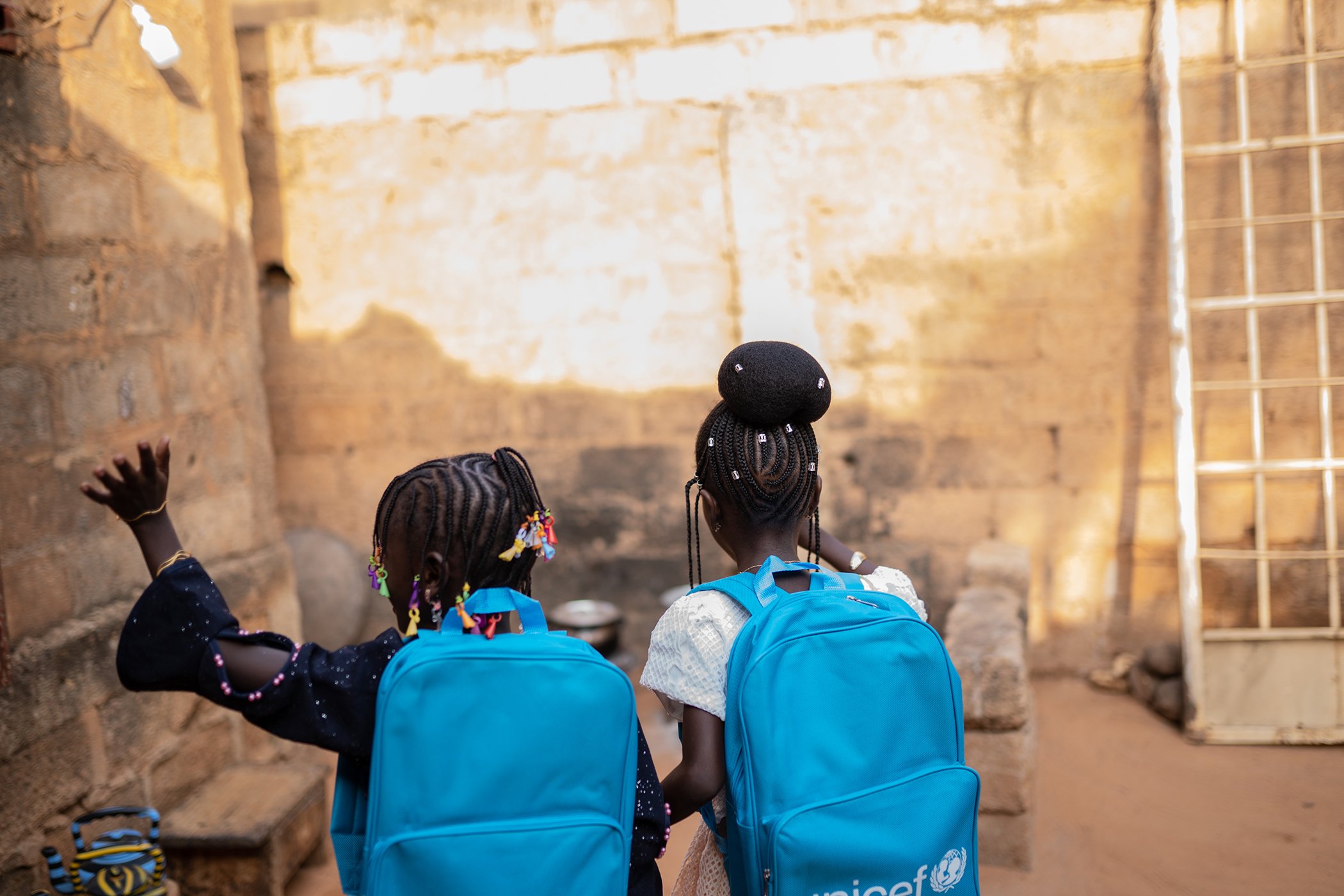 Two sisters walk on the way to their school in October 2020, after months of school closures in Niger. In the heart of the Sahel, millions of children returned to school after months of closure due to COVID-19.