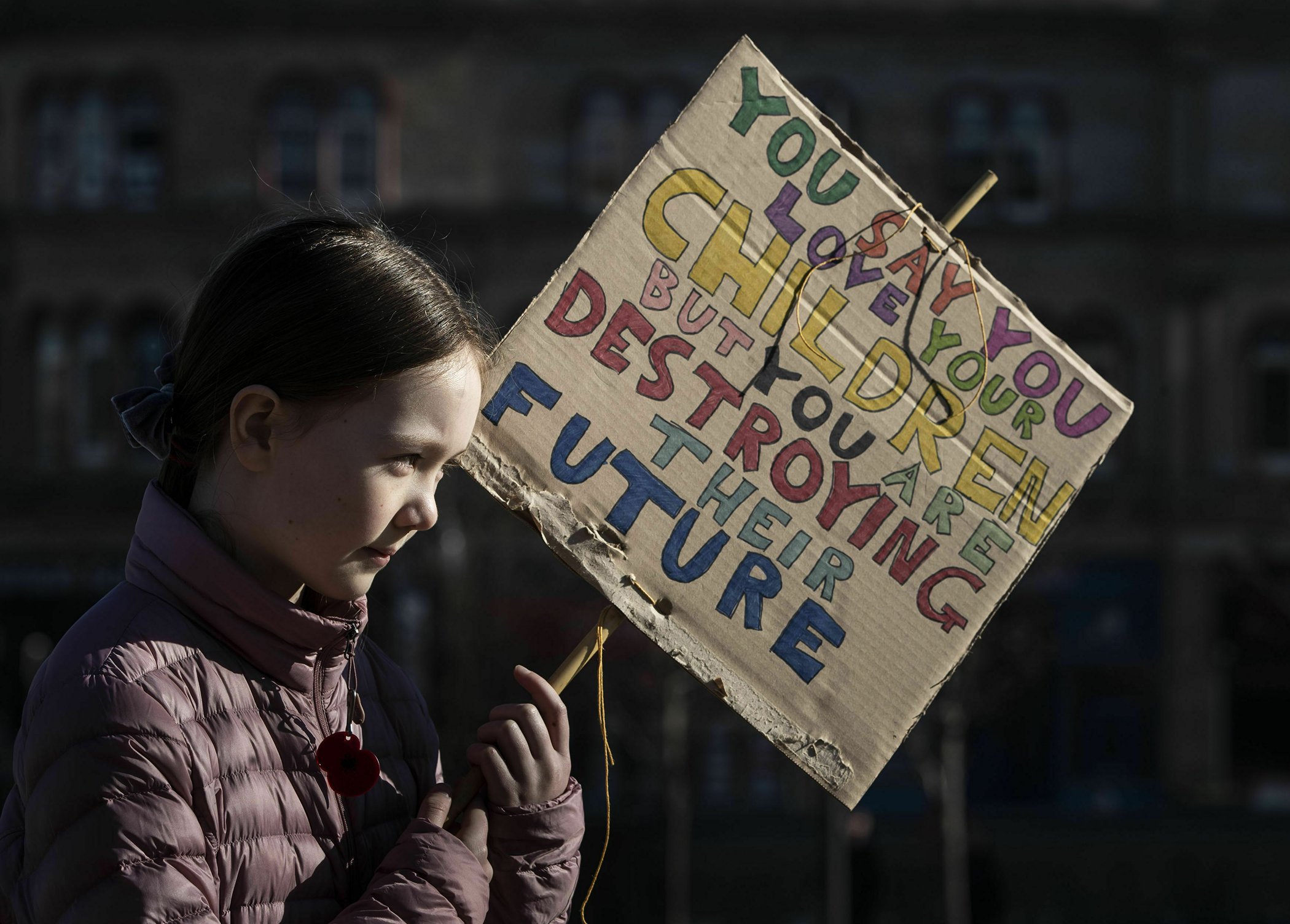 A girl displays a banner during a climate change protest in Huddersfield, England, Feb. 15, 2019. Chanting "Save our Planet!" thousands of students around Britain rallied to demand that Britain's Conservative government take action on climate change.