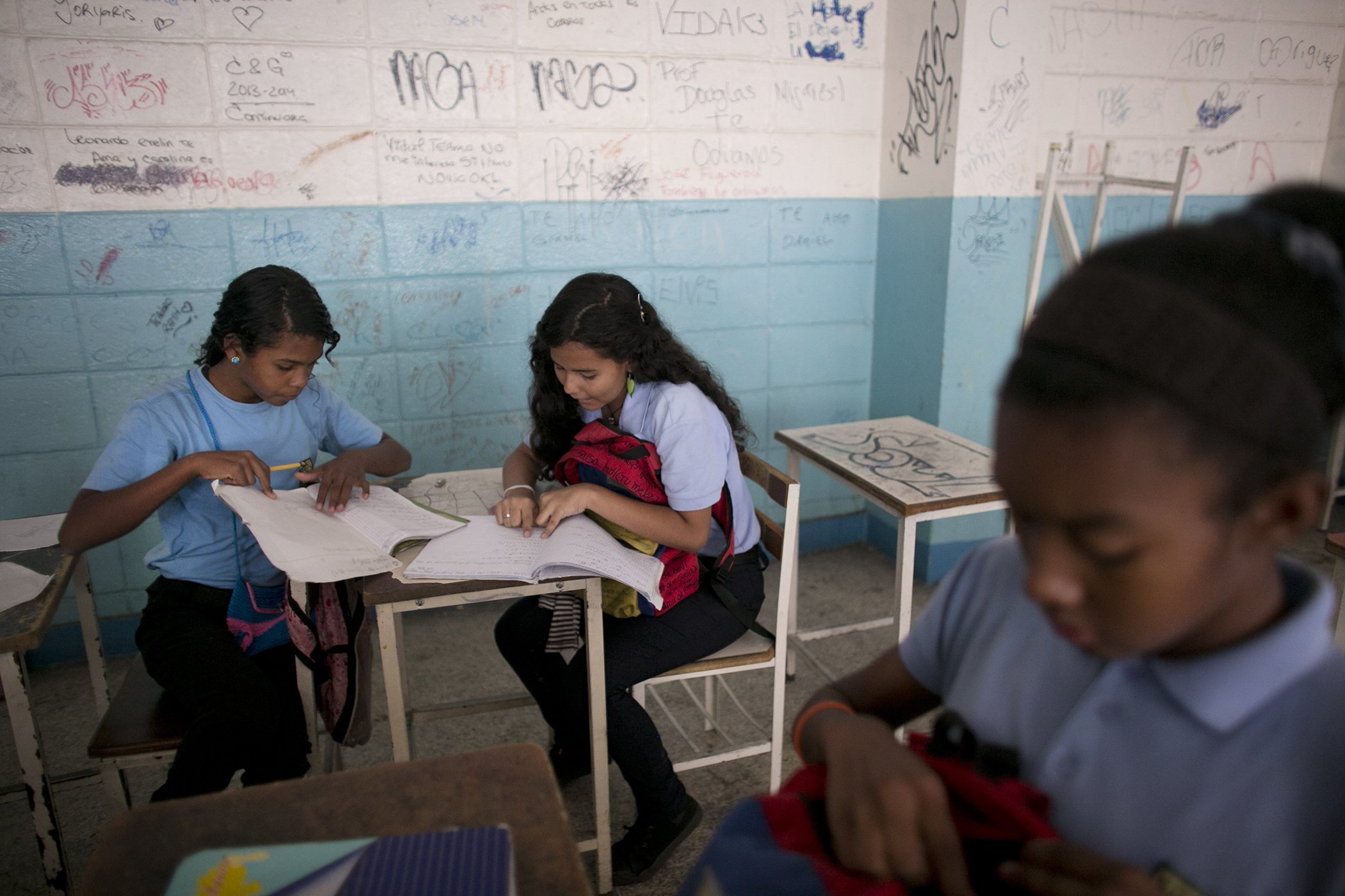 Students work together during a math class at her public high school in Caracas, Venezuela in June 2016.