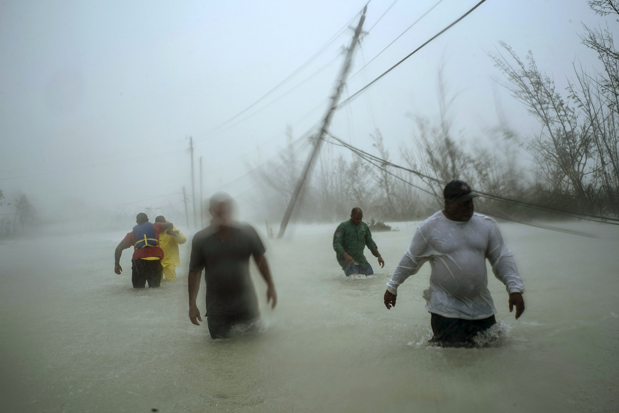 Dorian’s Devastation: Volunteers wade along a flooded road in Freeport, Grand Bahama, on Sept. 3, 2019, after Hurricane Dorian hit the island. Nominated in the spot news singles category.