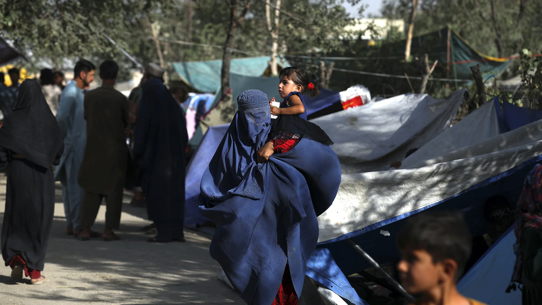 Internally displaced Afghans from northern provinces, who fled their home due to fighting between the Taliban and Afghan security personnel, take refuge in a public park Kabul, Afghanistan, Aug. 13, 2021.