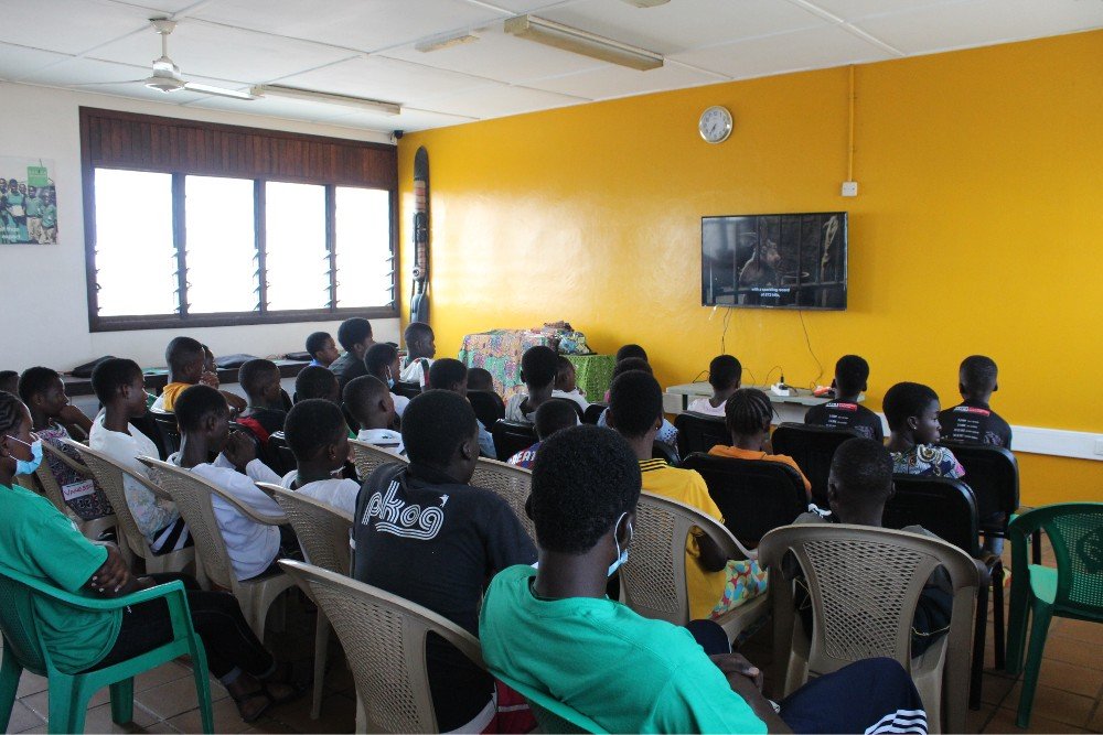 Children watch a movie at Nana's House