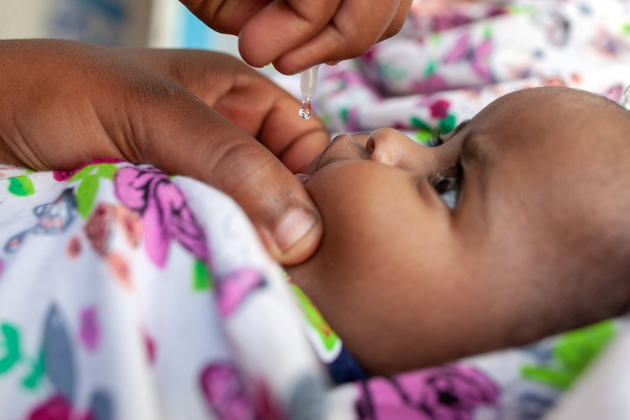 A 3-month-old child receives an oral polio vaccine at the DFID and UNICEF-supported Nutrition Health Centre in Hargeisa, Somaliland on Feb. 3, 2021.