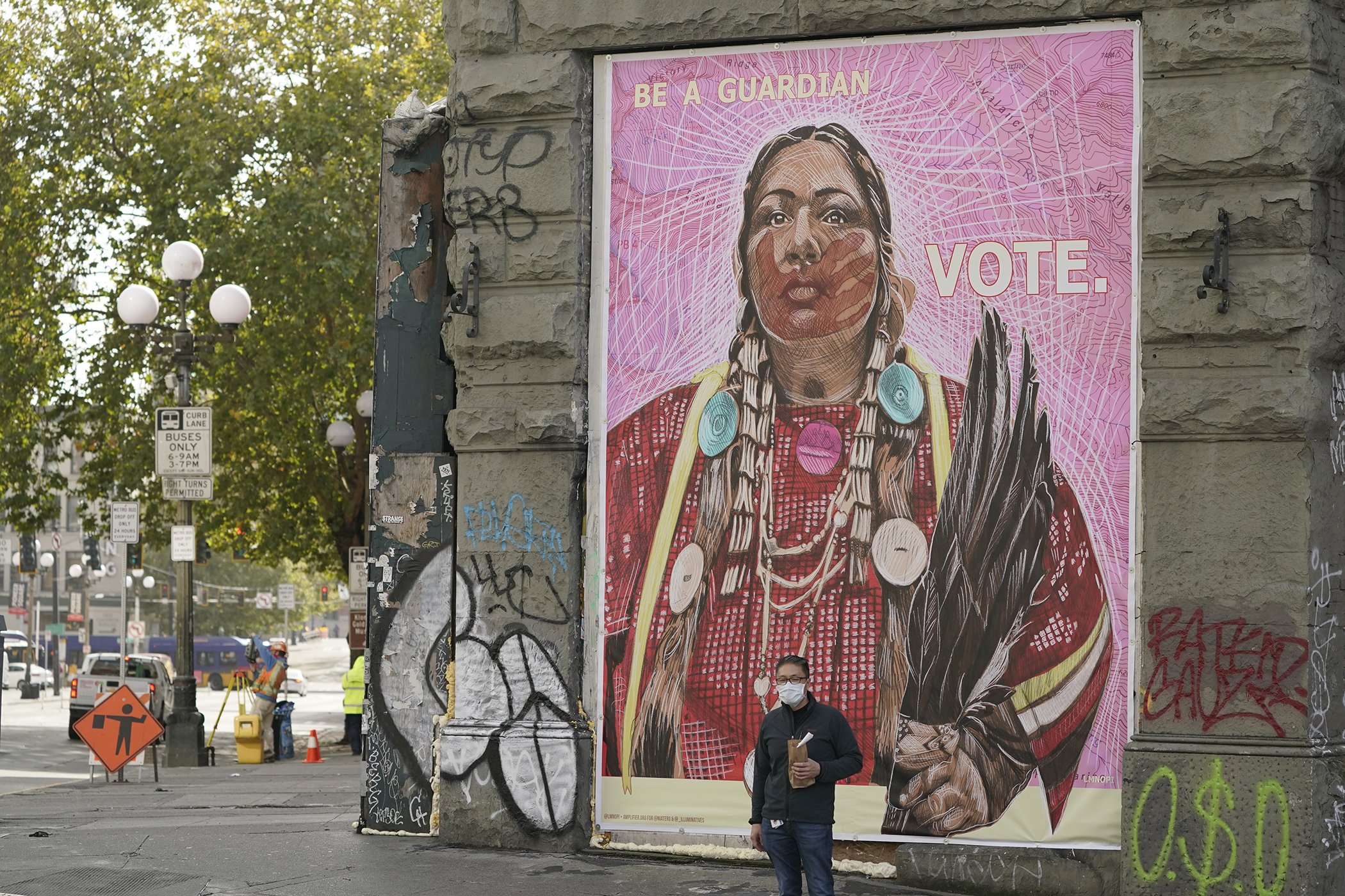 A mural by street artist LMNOPI encourages people to vote, Tuesday, Oct. 13, 2020, in downtown Seattle.