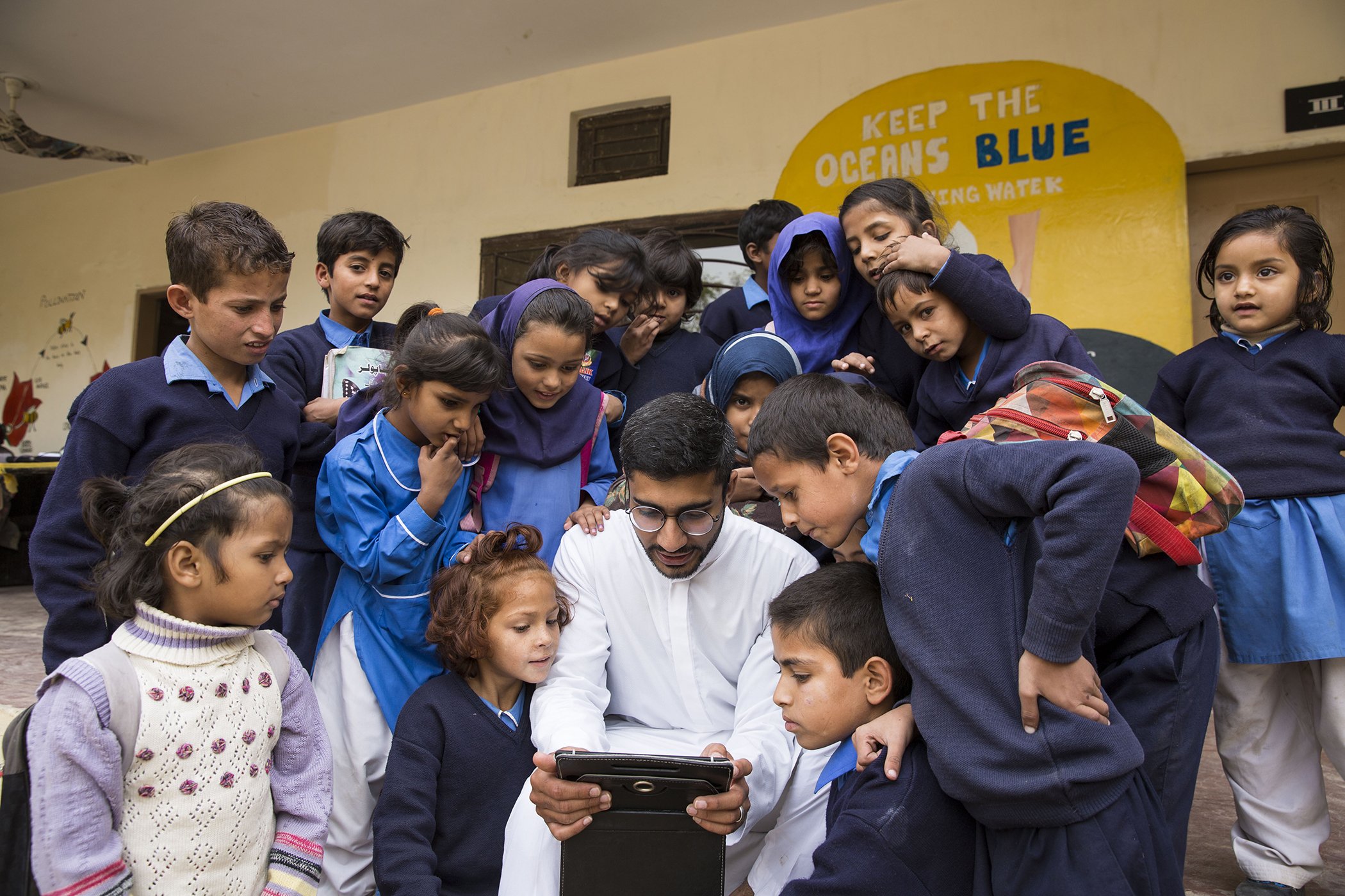 Haroon Yasin shows students the Taleemabad app at the Saya School in Islamabad, Pakistan on Oct. 9, 2019.