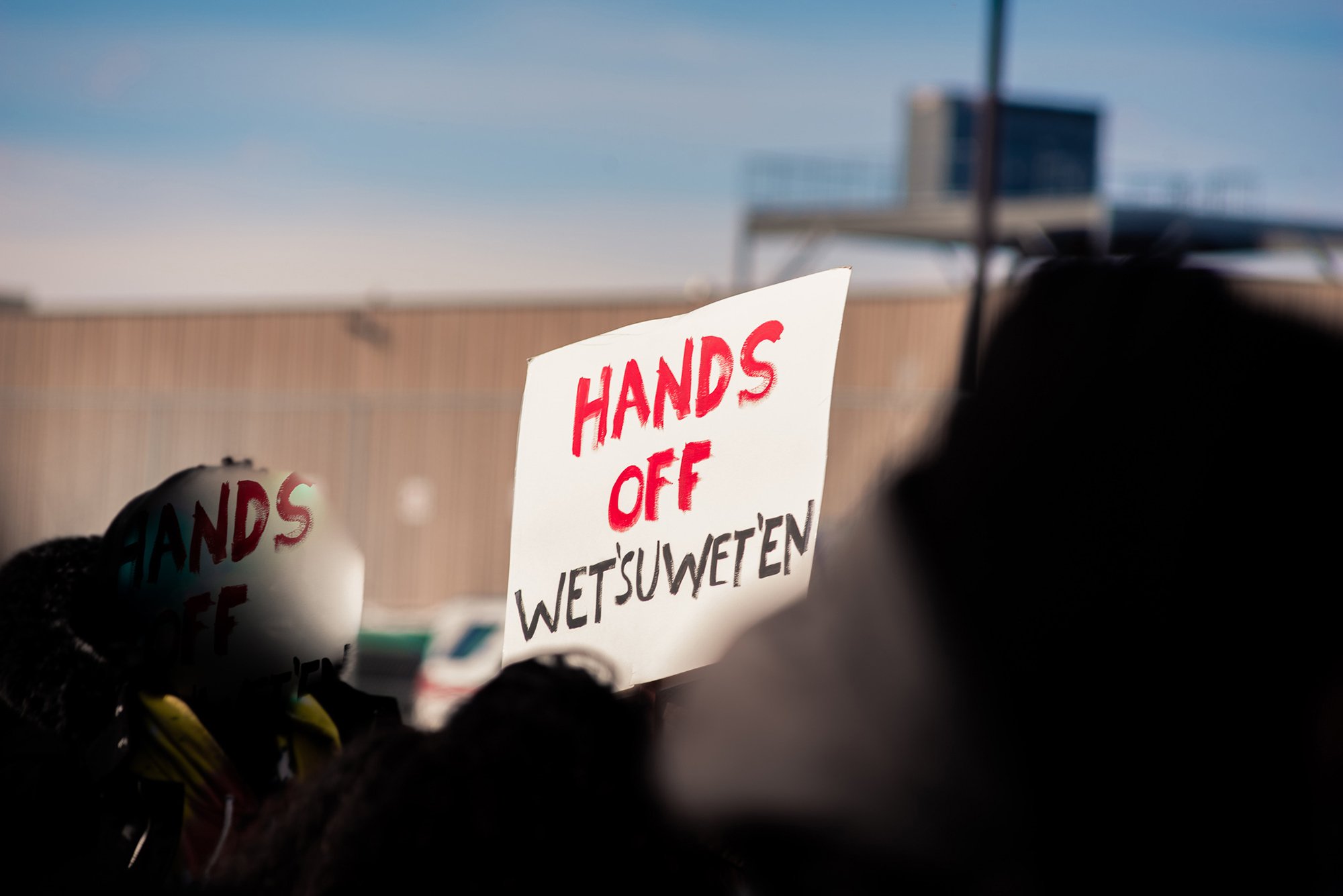 An attendee holds a sign that reads, "Hands off Wetsuweten," at a Wet'suwet'en Solidarity Event at the Rail Yard near Pioneer Village Station in Vaughan, Toronto, on Feb. 15, 2020.